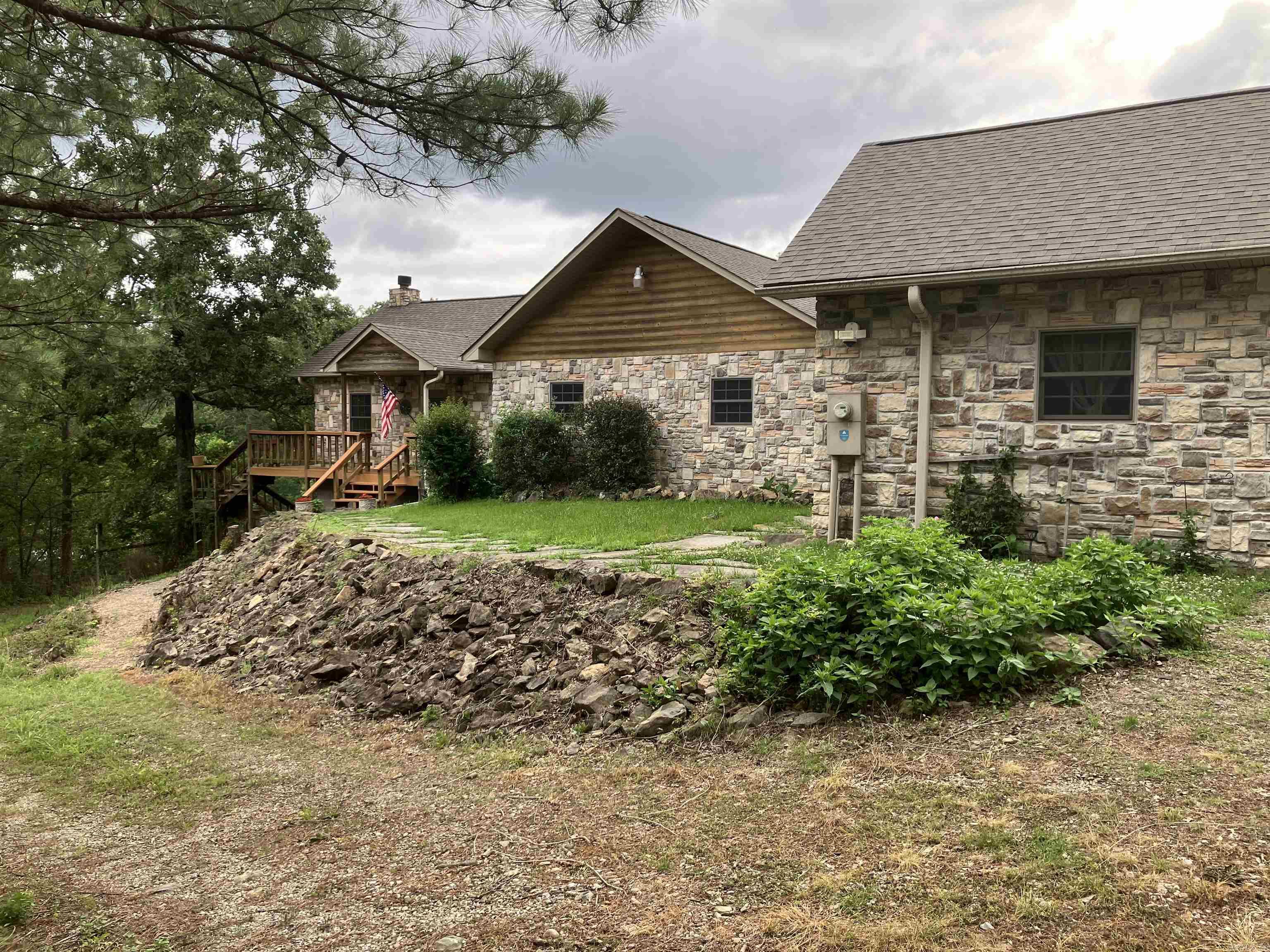 Lake living in a country setting. Are you looking for a lake front home but you don’t want the noise and traffic associated with the cramped neighborhoods on Lake Hamilton. Situated on 2.25 acres on the upper end of Lake Catherine with 210 feet of lake frontage and a boardwalk,  this property has 3 beds, 2 baths in the main house and living quarters in the garage with another bath. Exotic woods, granite, Delta fixtures, and Anderson windows are used throughout the house. Tongue and groove cathedral ceiling and Brazilian walnut floors, mahogany bar and African rosewood mantle and fireplace create a warm soothing atmosphere. Walk-in closets and lots of cabinets in the laundry room provides tons of storage. Outdoor living area features a 18x36 swimming pool, gazebo, bar and spacious decks all around the house. The 3 car garage and house are covered completely in centurion stone with log siding eaves. There is a 300sqft finished basement and a 12x12 storage building near the lake to store your toys. This custom house has everything a person could want. Come take a look and fall in love.