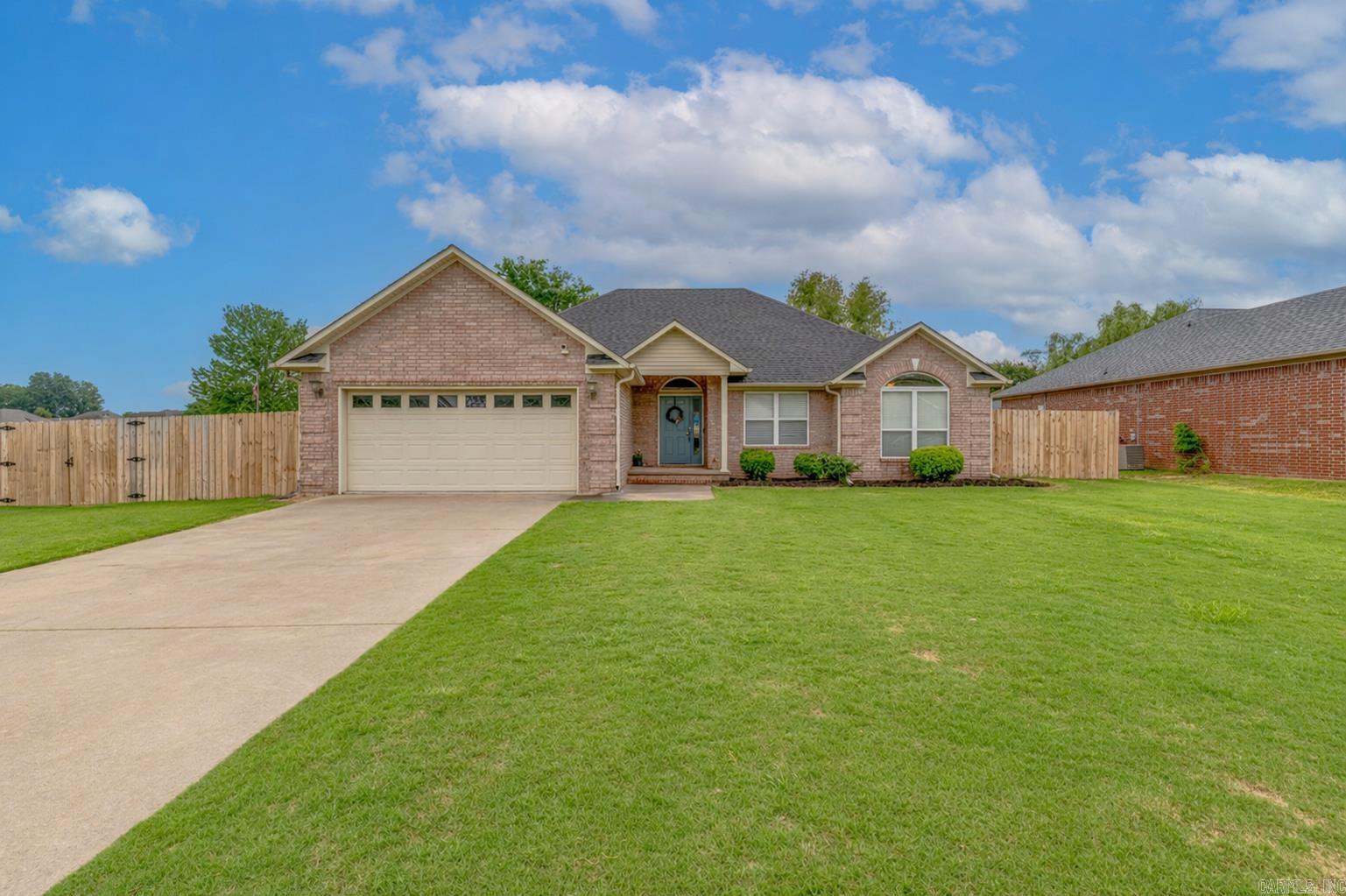 Don't miss out on this 4 bedroom all brick home in the Base Meadows Subdivision! Located on a fenced corner lot, with a front porch, back patio, and spacious backyard—perfect for outdoor living and entertaining. Inside you are welcomed by tall ceilings, a spacious entryway, and a functional, flowing layout. The kitchen is equipped with ample cabinetry, located conveniently in front of the garage door entrance. The living room features elegant oval tray ceilings and a gas log fireplace with a unique built-in mantle. This split floor plan offers a primary suite with tray ceilings and dual walk-in closets, a walk-in shower, and a jetted tub . On the opposite side of the home you have three additional bedrooms each with ceiling fans, including one with vaulted ceilings and a beautiful arched window. This house offers character while checking all the boxes.  Call today to make it home!