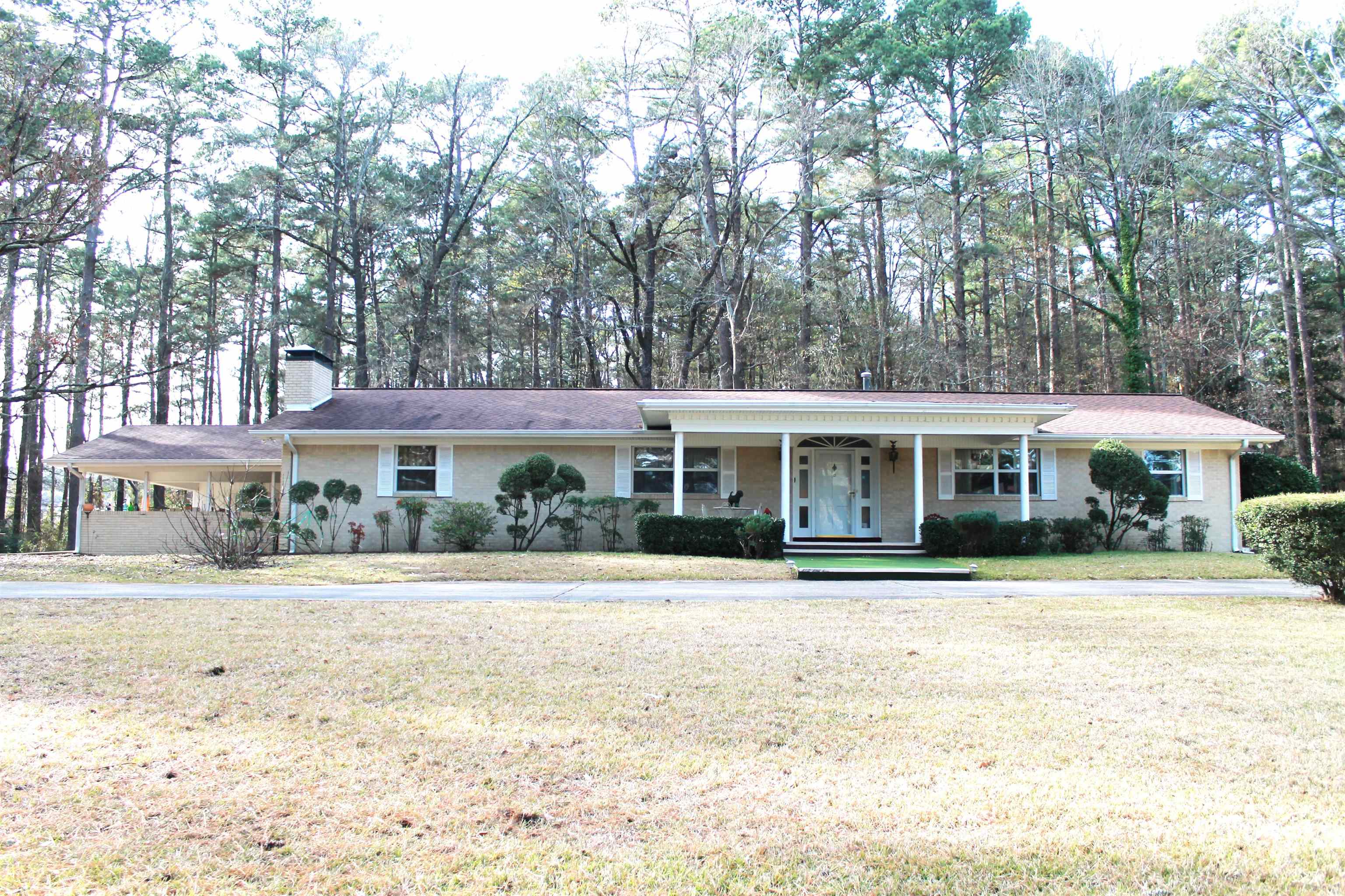 Beautiful setting on a hill with circle driveway; House sits on 2.50 acres and there is an additional 7.05 areas behind the house making it a total of 9.55 acres; Windows have been replaced; Gutters have leaf guards; Dehumidifier under house; Wood burning fireplace in family room; Office off family room that could be 5th bedroom; Sunroom; Barn storage building with electricity;