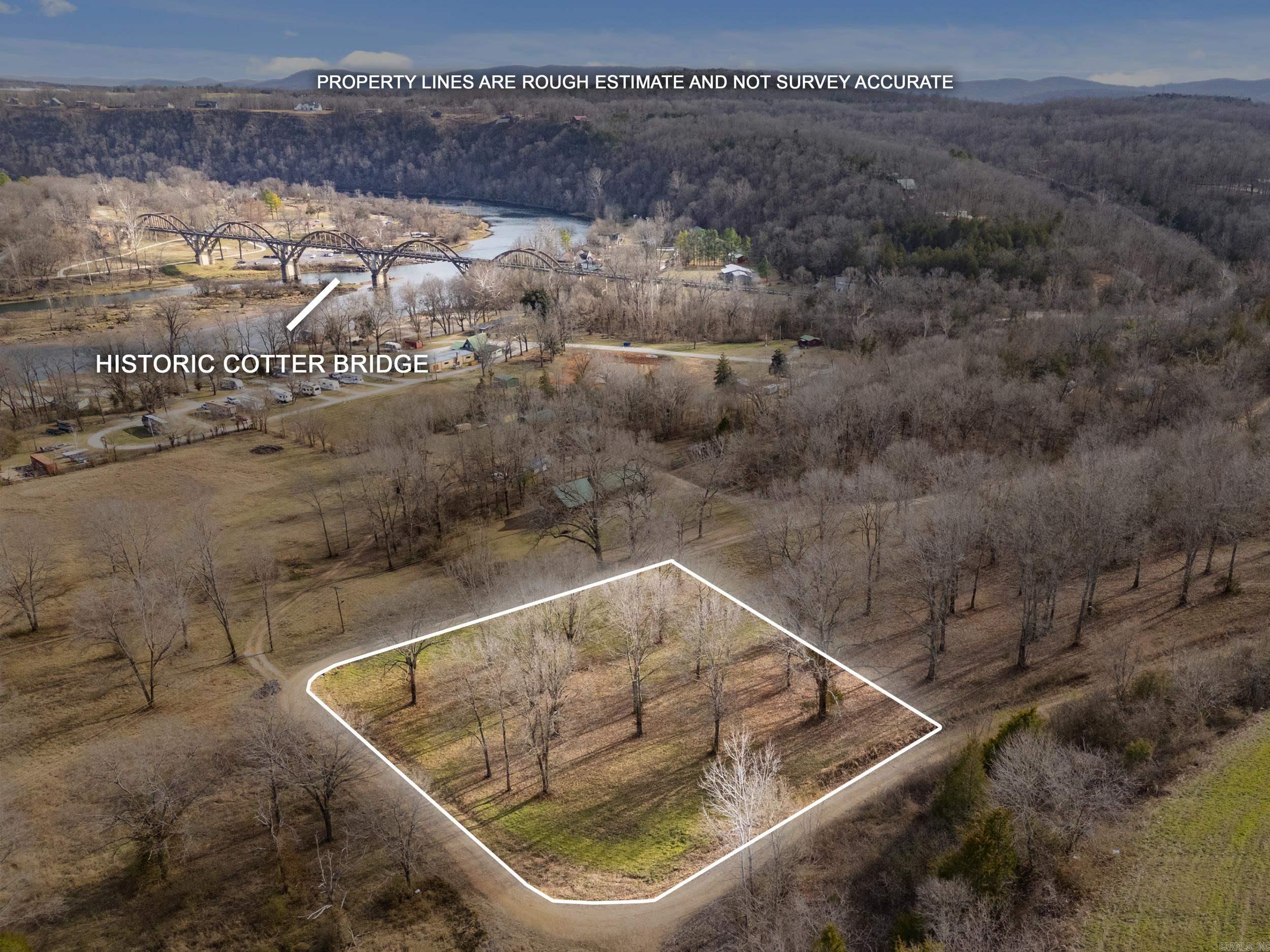 OWN A PIECE OF COTTER PARADISE where natural beauty, recreation, & opportunity come together. Welcome to an exceptional opportunity in the heart of Cotter, Arkansas—proudly known as the Trout Capital of America. This prime 1.24-acre cleared corner lot offers the perfect blend of natural beauty, convenience, & investment potential. Enjoy seasonal views of the legendary White River & historic Cotter Bridge while being just minutes from world-class trout fishing, public boat launches, & picturesque Cotter Spring Park. With electric & fiber internet readily available, this property is ready for your dream home, vacation getaway, or income-producing rental. Mature trees provide character & a scenic backdrop while maintaining the flexibility of a mostly cleared building site. Vacation rentals are permitted, creating excellent opportunities for short-term rental income in one of North Arkansas's most sought-after outdoor recreation destinations. Whether you're seeking a peaceful retreat, an investment property, or a place to build your forever home, this rare parcel places you near fishing, floating, hiking, & the charm of small-town living.