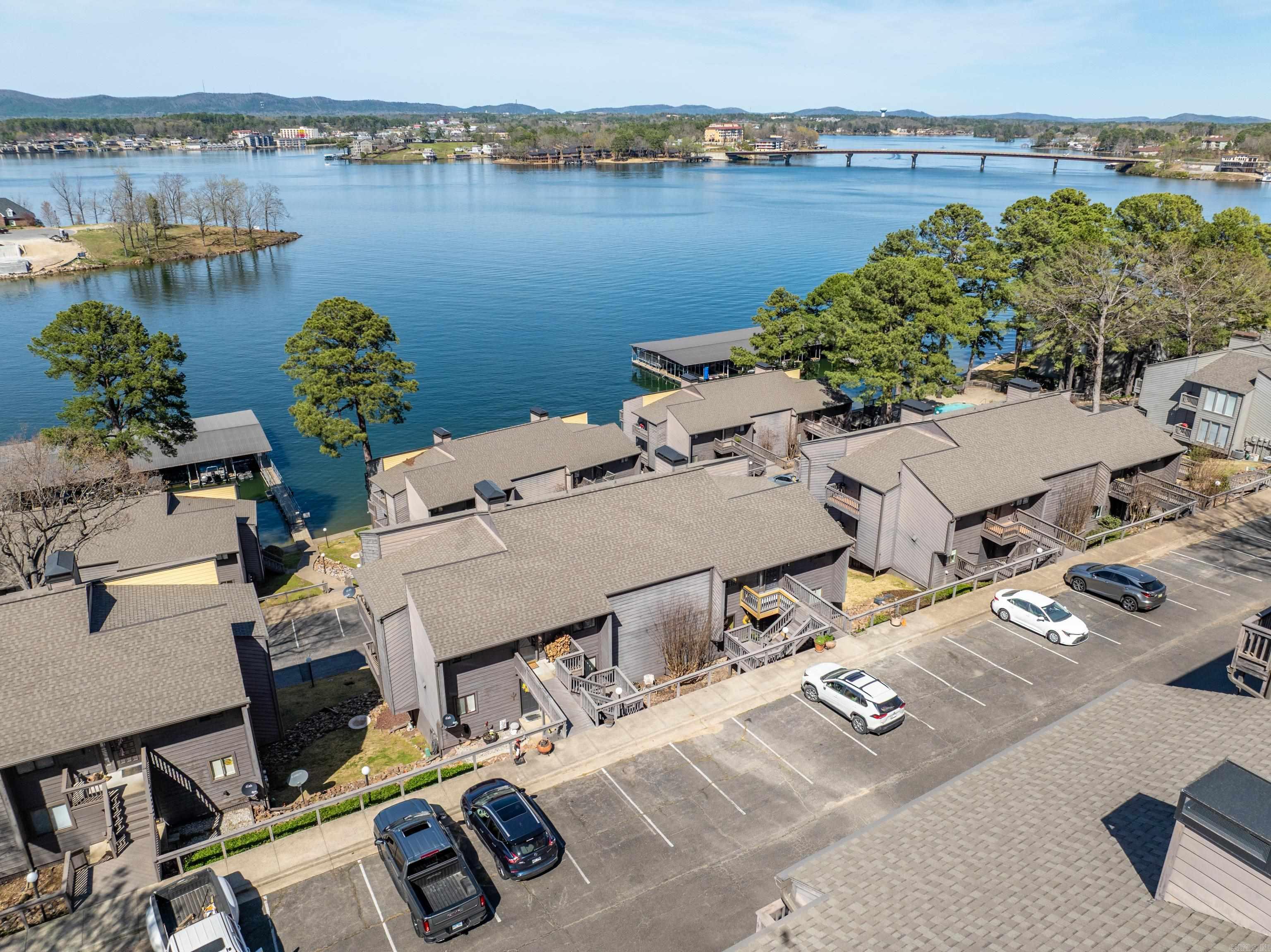 Welcome to this beautiful 2-bedroom, 2-bathroom condo offering stunning lake views in a peaceful and private setting off of Seven South. Located in a safe and secure gated neighborhood, this home provides the perfect balance of relaxation and recreation. Enjoy resort-style amenities including tennis courts, a sparkling pool, and a hot tub—ideal for weekend getaways or entertaining guests. The open-concept layout is designed for comfort and style, with generous natural light and serene water views of Lake Hamilton. Whether you’re looking for a full-time residence, vacation retreat, or investment property, this community allows rentals, making it a versatile opportunity.