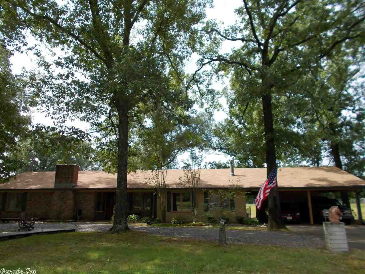 This is a wonderful brick home located on the outskirts of town. Home features a large den with a wood stove, formal living room with a fireplace, nice kitchen with lots of cabinets, large deck, gazebo, storage building and more.