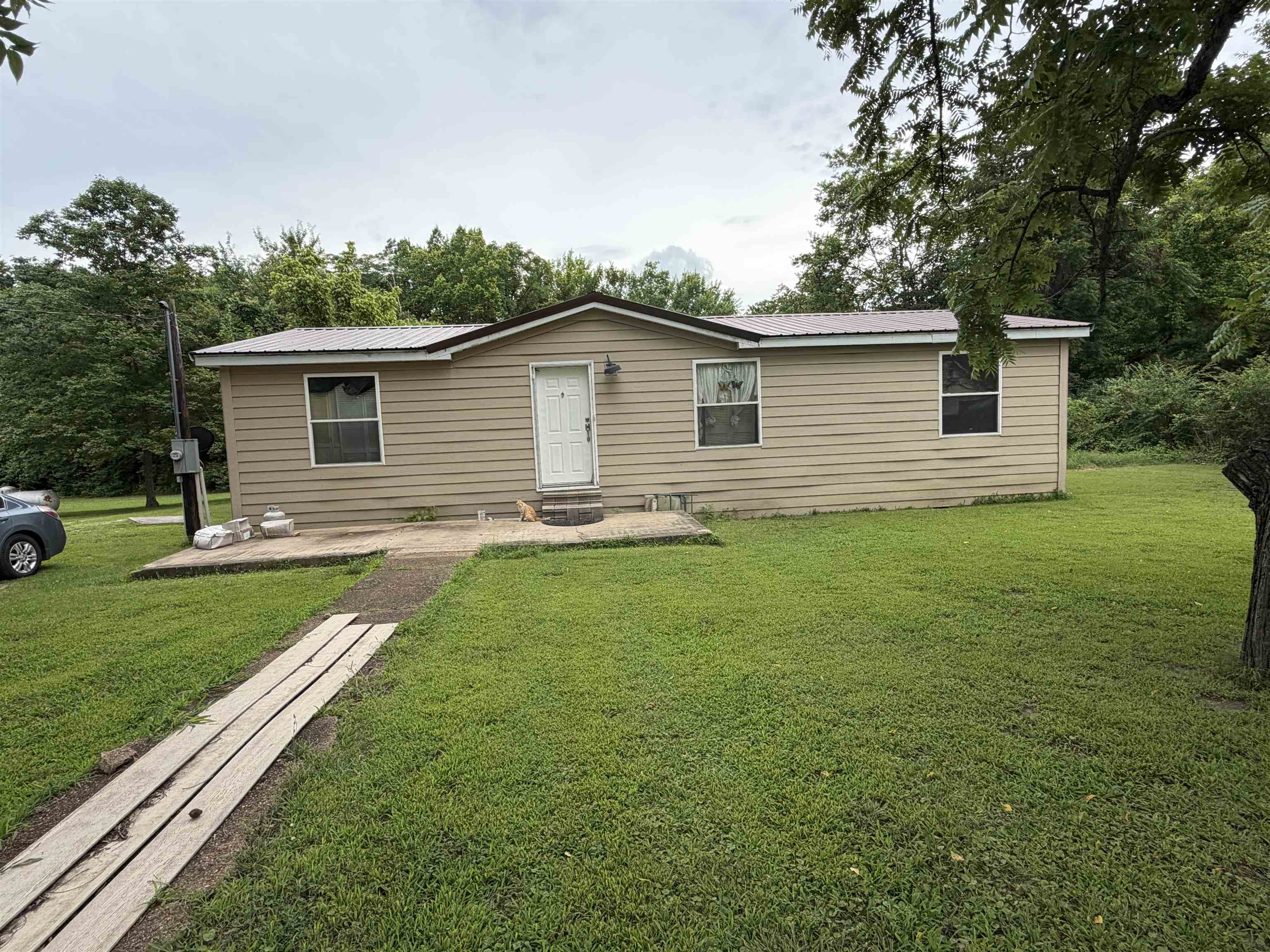 Updated  all electric 3 bedroom 2 bath 2000 manufactured home with detached oversized 2 car garage. It has room for two cars and shop-storage area.   Recent updates, along with ongoing projects: Vinyl flooring, interior paint, siding, some bathroom updated,  metal roof in 2021. Central HVAC, kitchen includes refrigerator and stove, and new dishwasher. It's a nice location near the end of a dead end street.
