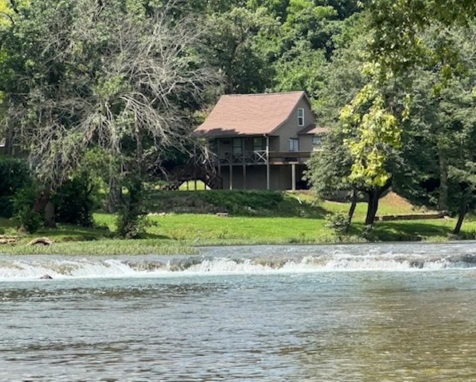 If you are looking for South Fork River frontage-over 150 ft! --with easy  access to the river, this 3 bedroom 2 bath home should be on your short list. This is an opportunity to acquire a  furnished home with central HVAC, kitchen appliances, washer and dryer, beds, etc.  included. The living quarters are above past flood levels, per the owner. The tall crawl space has ample room for storing yard tools and water toys. There is enough headroom for this  "crawl space" to become a finished basement, with an outside access only.  A deck wraps two sides of the house with plenty of room for enjoying the  out of doors and some really great views of the river.