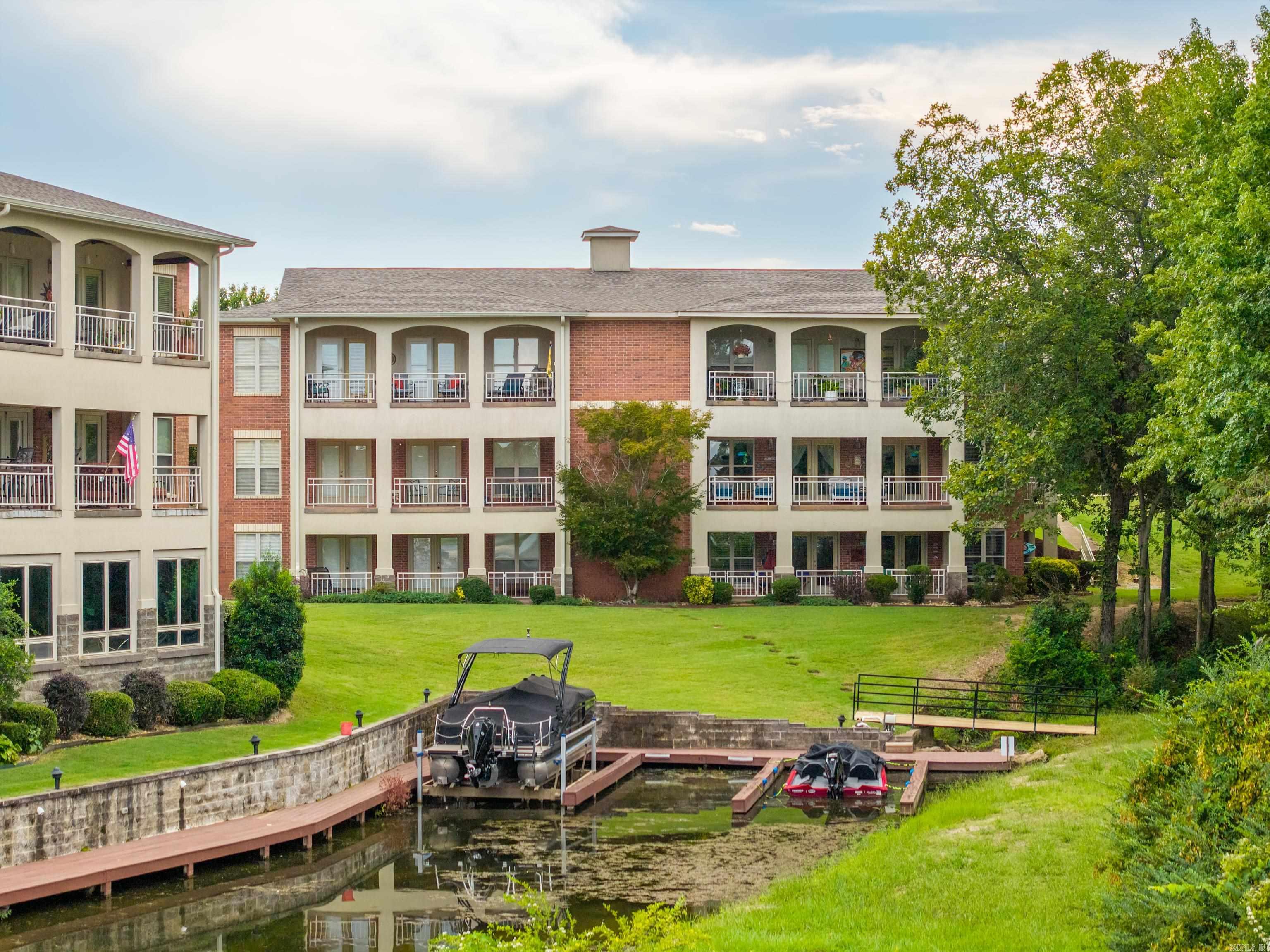 This rare and unique Millennium Bay beauty has extras upon extras leaving no amenity unturned!  Boasting 3,440 square feet, this spacious two-level unit is like having two condos in one.  The upper level is conveniently walk-in, open concept living, and includes a primary suite and a guest room and guest bath.  Downstairs opens up into another open concept living space with another full kitchen, two bedrooms and one and a half baths.  Both levels also have two balconies to enjoy the peaceful setting and of course lake views.  The lower level also has it's own exterior entrance making this a great opportunity for an in-law's quarters, large family, or if you just want extra space to entertain your guests!  You also have the ability to lease the units separately making this also an income opportunity.  This unit also comes with a boat slip!  Enjoy the beautiful pool & picnic areas, gorgeous grounds, and the convenience of the community boat ramp.  Unit U1 is also located at the end of the cove and the perimeter of the complex that gives added privacy by bordering a wooded area.  Aside from the one car garage, U1 also has three additional parking pads.  Must see!  Call today!
