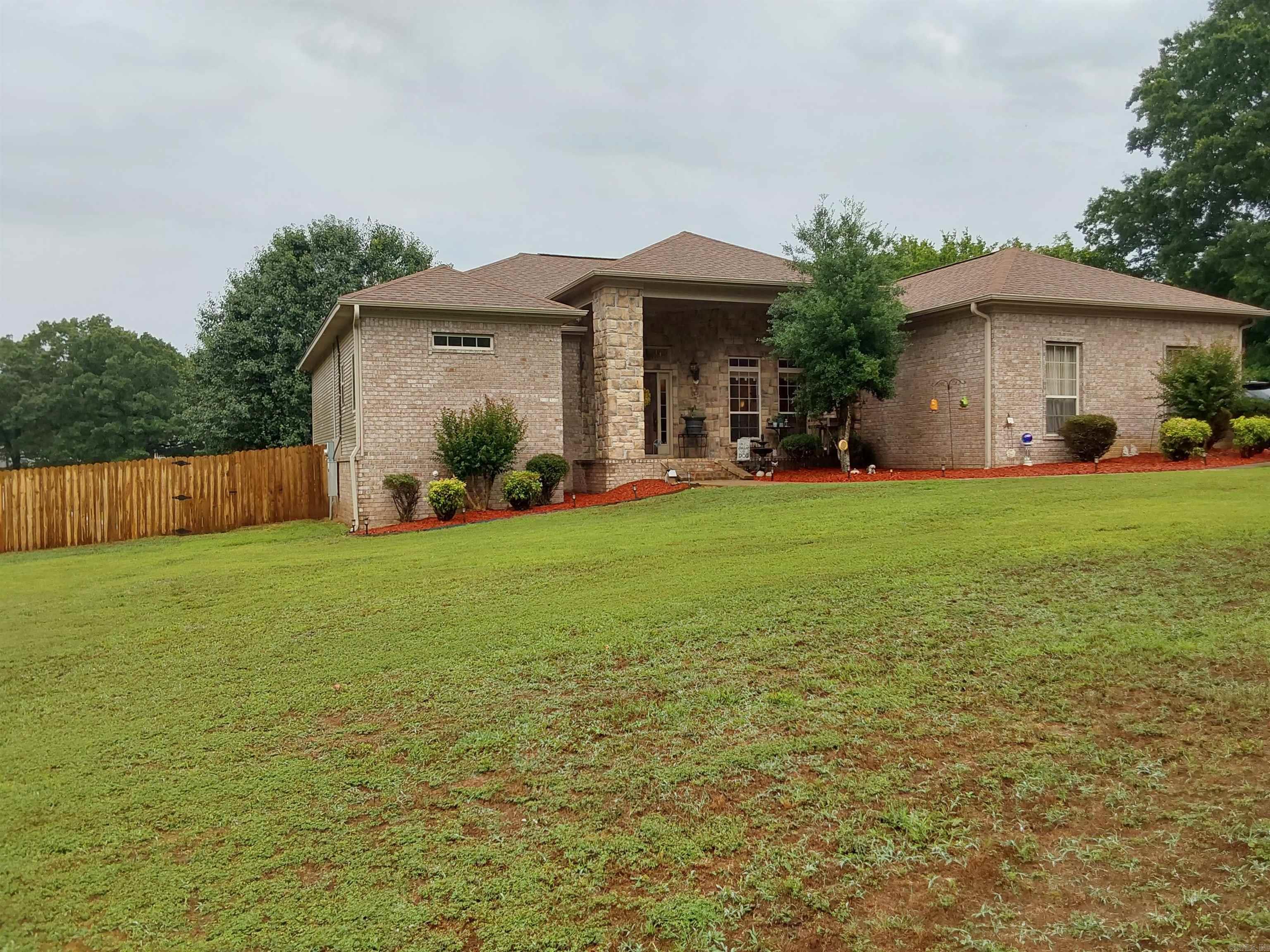 Check out the awesome 4 bedroom, 3 bath New Carpet, New LVT Flooring, New Paint,  BONUS IT HAS A FULL MOTHER-IN-LAW QUARTERS WITH PRIVATE ENTRANCE, PARKING PAD, AND PRIVATE PORCH ON BACK. You want to see this house! The home features 2 living areas, crown molding throughout, awesome kitchen with custom built-in cabinets with silestone countertops, tumble stone backsplash, over and under counter lighting, stainless steel appliances, separate dining room Living room has electric log fireplace with beautiful mantle. Check out the 12 ft ceilings in entry and separate dining room. Separate laundry room, 2 car garage with new garage door and opener. Beautiful fenced in backyard overlooking the awesome pond! Back porch as partial cover, private backyard to enjoy all the wildlife. This house has so much to offer!! HVAC 2019!!  Storm Shelter, STORAGE BUILDING CONVEYS WITH PROPERTY. New Roof And New Rehab Deck AGENTS SEE REMARKS.