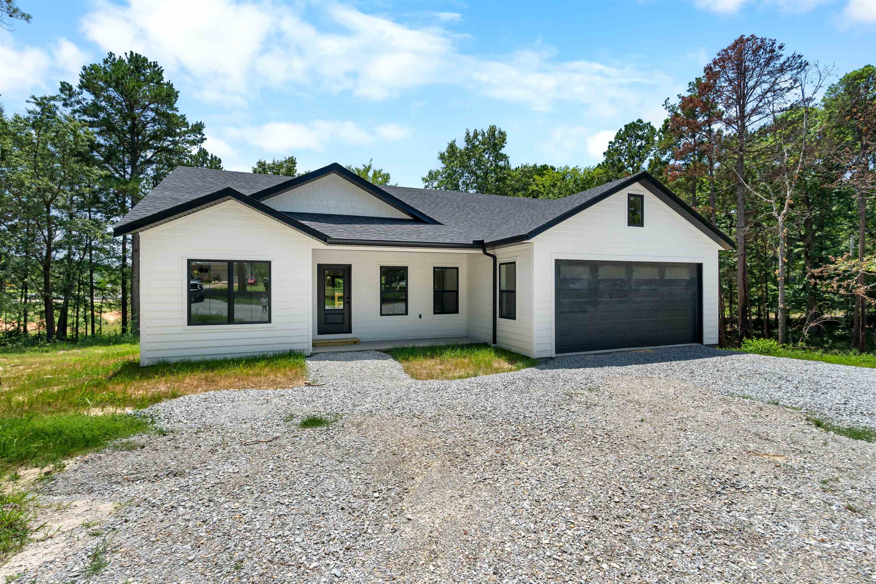 NEW CONSTRUCTION located in Calico Rock! This custom built 3 bedroom, 2 bath home offers an open floor plan with oversized windows throughout for  natural light. The kitchen features a large island, great cabinet space, a pantry, and adjoining dining area. The master suite is complete with a walk in closet and an attached bathroom featuring a large vanity with double sinks and a custom tile walk in shower. Two great sized guest bedrooms provide plenty of space for family or visitors, and the oversized laundry room offers additional storage or room to expand to fit your needs. Outside, you'll find a fully finished two car garage and a large back deck. Conveniently located just minutes from the White River and beautiful Lake Norfork, this home is ideal for those who love fishing, boating, and the outdoor lifestyle.