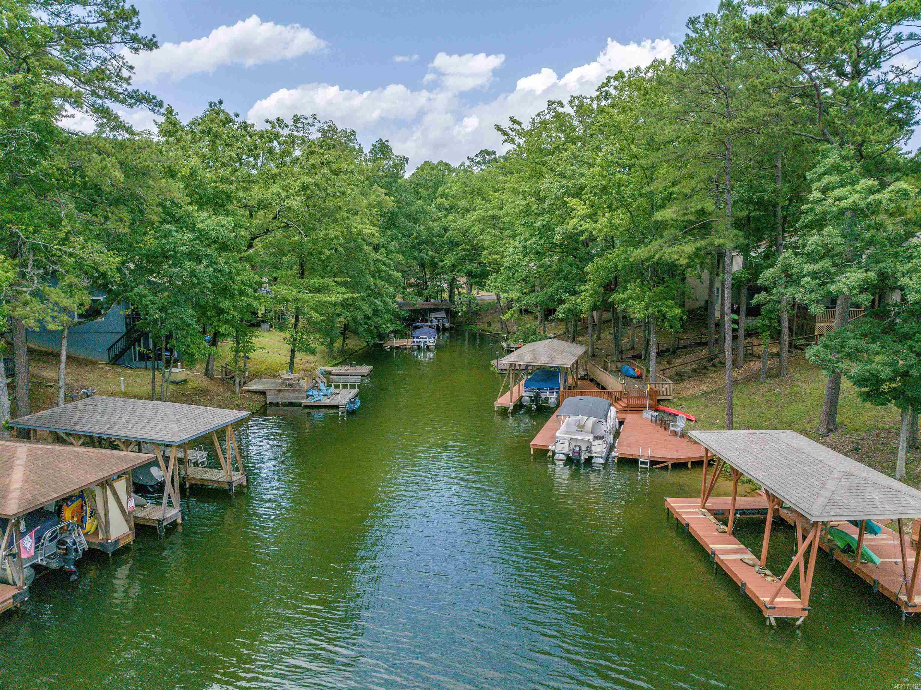 3 Bedroom WATERFRONT townhome on Lake DeSoto! Enjoy Sunsets from your Back Deck or the Lower Patio! BRAND NEW ROOF! These units make great Nightly Rentals! There is an oversized Laundry/Storage/Owner's Room (in addition to the 3 Bedrooms). Lake DeSoto is one of 4 Full Recreational Lakes in Hot Springs Village (water ski lake)! This 200 acre lake offers a Beach, the Waypoint Marina, Boat Launch and Walking Trails! Hot Springs Village boasts 11 Lakes & 9 Golf Courses, Tennis, Pickleball, Mini Golf, Bocce Ball, Lawn Bowling, Dog Park, Fitness Center, Indoor & Outdoor Pools, Performing Arts Center, Archery Range, 20+ Miles of Walking Trails, and much more!