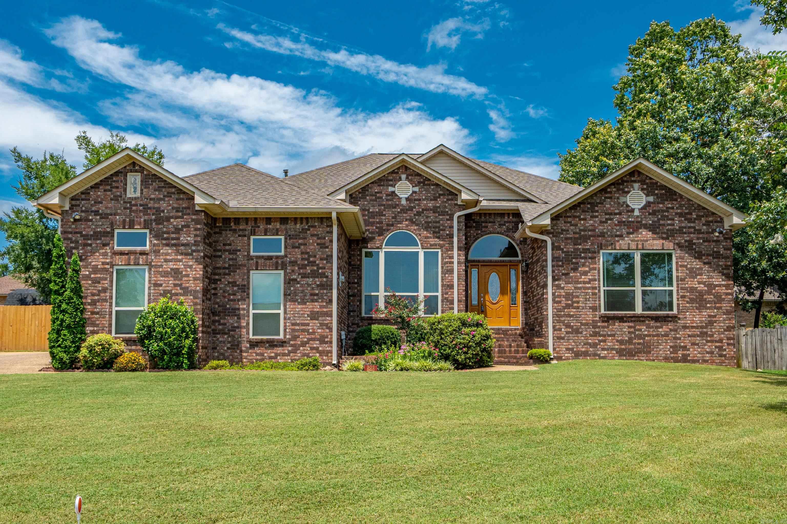 THIS LOVELY FAMILY HOME IS "LIKE NEW"!  LAKE ACCESS + 4 BEDROOMS 2 BATHS IN LAKE HAMILTON SCHOOL DISTRICT.  A beautifully maintained home that is open, light and bright with transom windows & skylights and newer windows throughout and offers a Large Dining Room and Living Area with a Fireplace and Built-In Cabinetry, an Oversized Kitchen with Pantry + Stainless Appliances and Gas Stove, a Breakfast Bar + Breakfast Nook.  All bedrooms are one one level of the home and the Master Suite is sequestered with a large bedroom, an updated bathroom, and spacious walk-in closet! Outdoor you will enjoy a covered patio, recently new privacy fencing, a great custom built storage building, and beautiful landscaping.  The neighborhood provides a great area to walk and this location offers easy access to schools, shopping, restaurants and medical providers.    The roof and heat/air were replaced in 2024, the paint is fresh and this home is a PLEASURE to show!