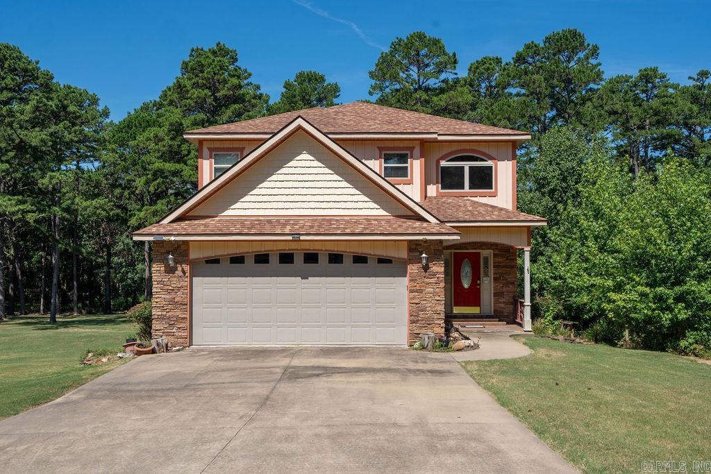 Lakefront living across from Thunderbird Country Club and Golf Course! This custom-built 4 bed, 3 bath home sits on a level 1.71-acre lot with two path permits and a good beach area—perfect for lake enjoyment, easy walk to the water with your canoe, kayak or lounge chair. With 2,348 sq ft, it features bamboo floors, upscale tile, granite countertops, custom cabinetry, and exquisite lighting throughout. Bathrooms showcase unique tile work, with motion-sensor lighting. One bedroom is on the main floor, the other 3 are upstairs. Two decks for outdoor entertaining, 2-car garage, spacious yard. Storm shelter under the house, extra stove and sink in the garage for additional cooking space. Recent updates include a new wrought iron fenced backyard (2024), HVAC systems (2022 & 2023). Roof is believed to be original from 2015. Convenient to boat launch area and across the road from golfing and club swimming pool!