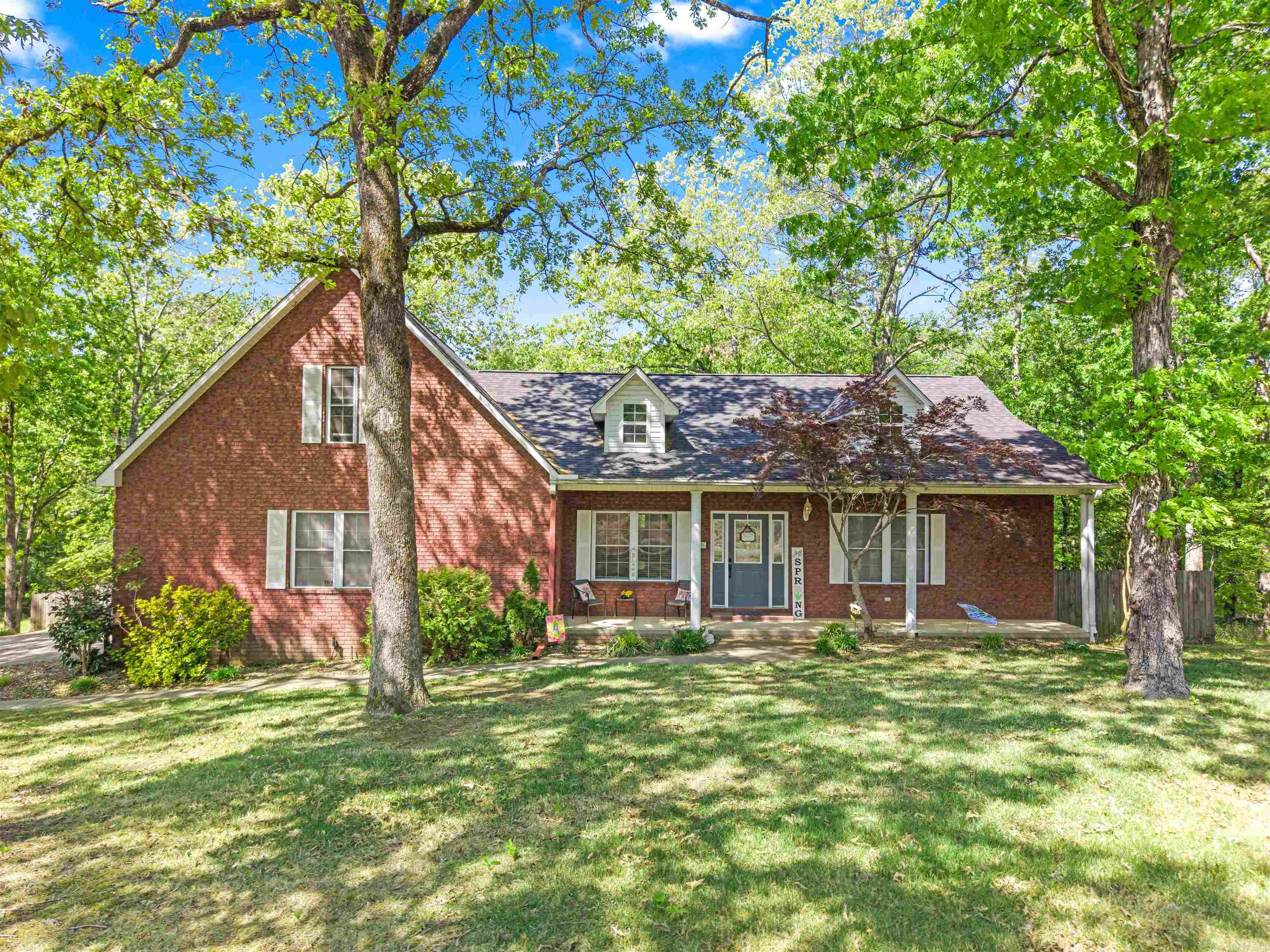 Situated on a one acre lot, this meticulously maintained 4 bedroom home offers the perfect blend of luxury and practical living. The interior features gleaming hardwood floors throughout, and the main level has a bright and open floor plan with a wood-burning fireplace as its centerpiece. The kitchen is fully equipped with modern stainless steel appliances. You’ll find three spacious bedrooms on the main floor, along with two full bathrooms and a dedicated home office. Upstairs is a private fourth bedroom complete with its own full bathroom. In addition to the standard two-car garage space, a third garage door provides easy access for a motorcycle, lawn equipment, or workshop tools.