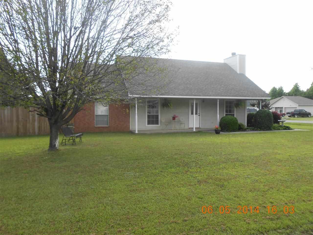 All the updates have been made to this pretty home!  Sitting on a large corner lot, this home offers tile & wood flooring throughout (no carpet),  2" blinds, nice fireplace, new lighting, new paint, alarm system.  Kitchen has stainless steel appliances, pantry in laundry area.  Both bathrooms look great!   Large fenced in back yard with pad for camper.  Extra landscaping!  New roof in 2011.  Move in ready!   Please give at least 2 hours notice before showing.