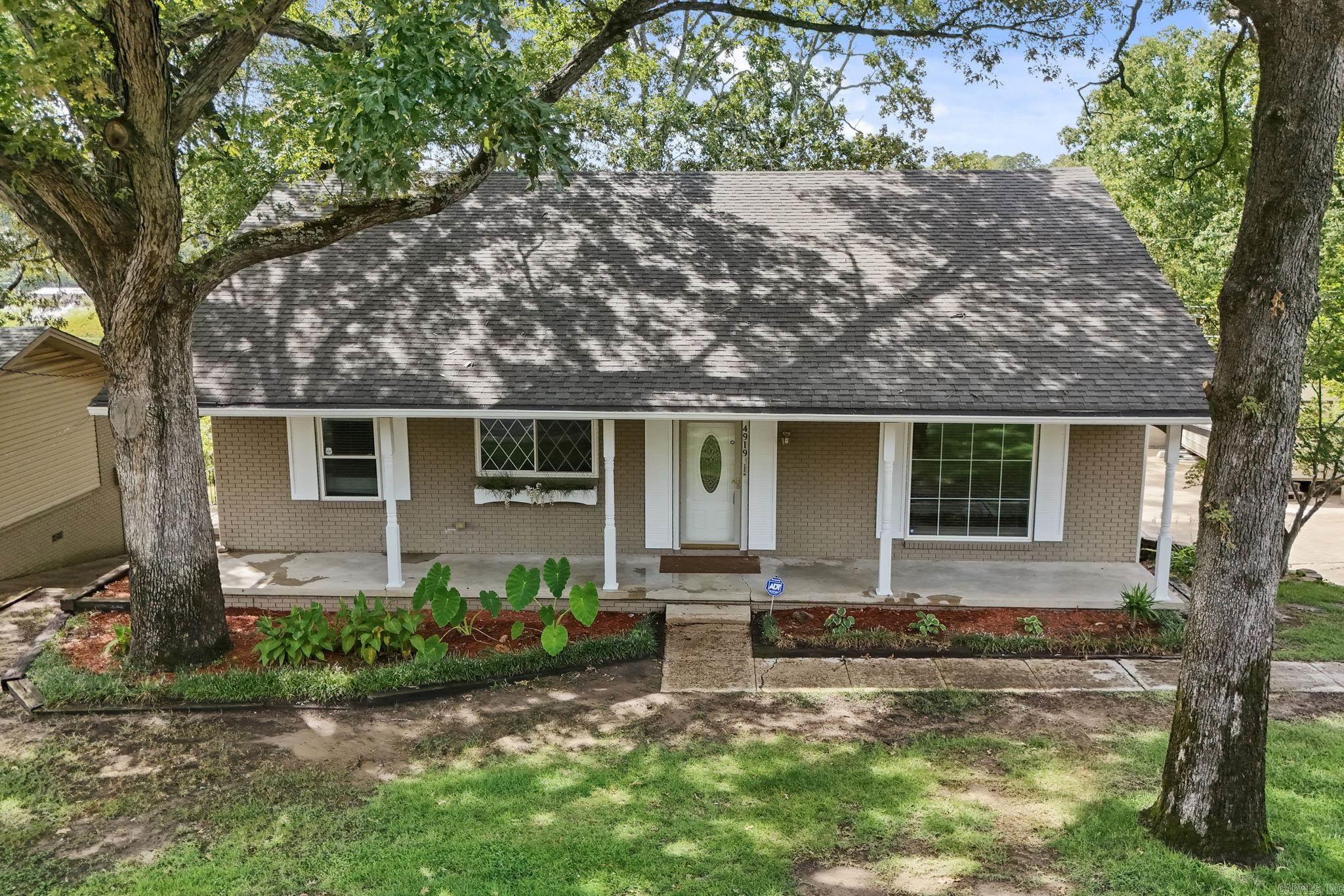 Wonderful home sitting in the heart of North Little Rock's popular Lakewood neighborhood. Inside this lovely spacious home you will find fresh interior paint, newer stainless appliances, abundant cabinets, beautiful original hardwoods, updated windows and bathrooms. Hearth room with gas log fireplace, in-laws quarters with separate entrance, heated and cooled sunroom, large laundry room. Outside you will find a spacious 8x16 storage building, hot tub and enclosure, basketball court and patio. Hot tub and enclosure conveys at no value, as is.  This is a great house with room for everyone. Walk to the Old Mill, take a leisurely stroll around a beautiful lake, shopping, coffee shops and just minutes away from tons of other conveniences. Licensed appraiser provided measurements. See associated documents. See agent remarks