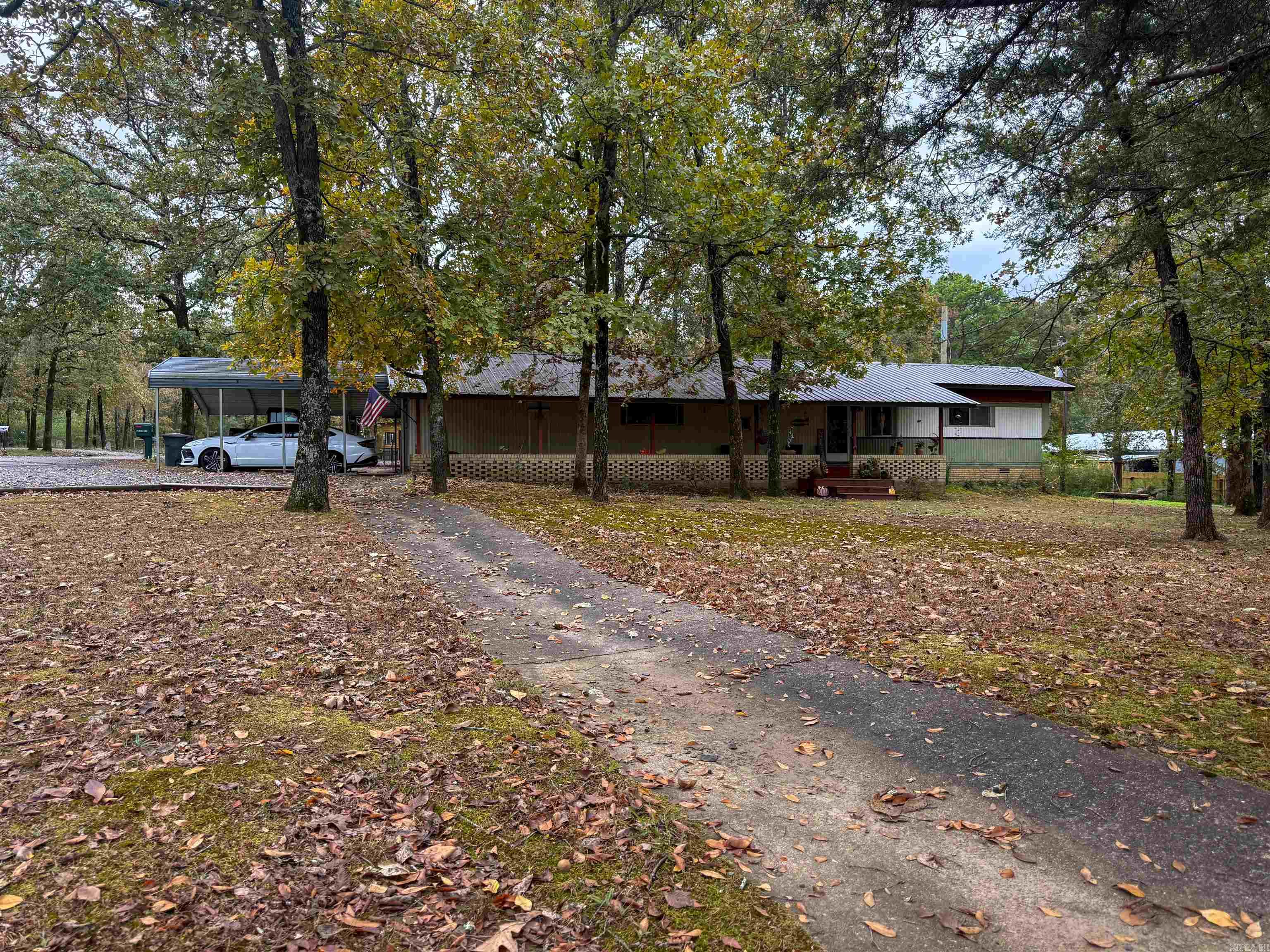 Just seconds from Greers Ferry Lake, boat launches, and all the small-town charm of Greers Ferry, Arkansas, this tastefully updated 1978 manufactured home offers comfortable living and incredible outdoor spaces on a spacious .89-acre corner lot. Step inside to find new flooring and subflooring throughout, new plumbing features throughout, updated bathrooms, and an updated kitchen featuring new appliances, countertops, and fresh finishes. The metal roof and dual-fuel heat pump provide year-round peace of mind and energy efficiency. Outside, you’ll love the multi-car parking, 2-car carport, partial fencing, greenhouse, and four outbuildings ranging from storage-size to extra-large — perfect for hobbies, tools, or lake toys. And the true highlight? The custom-built “Party Hut” — your ultimate entertaining retreat! Complete with exhaust fans for temperature control, full-size bar with sink, mini fridge, and TV hookup, it’s ready for game days, get-togethers, or relaxing weekends after a day on the lake. Whether you’re after a weekend retreat, full-time home, or investment, this one has it all—charm, updates, and true lake-country living. Boat slip will convey.