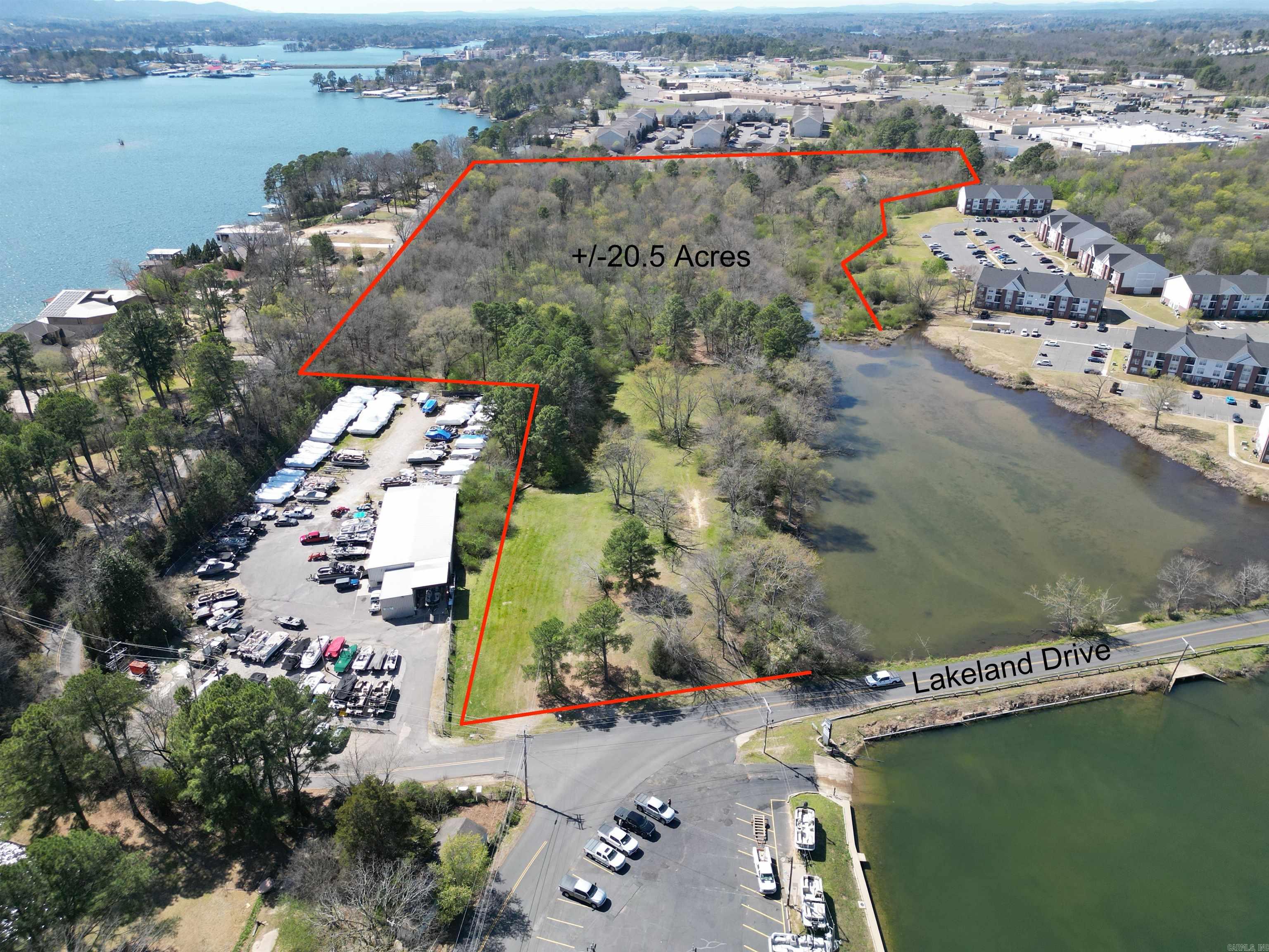 This 20.32-acre property, consisting of two combined tracts, presents an exceptional opportunity for residential development in a growing, high-demand area. Zoned R5 Medium/High Residential, the possibilities are extensive — ideal for apartments, duplexes, townhomes, or single-family residences. Conditional uses also allow for charitable institutions, lodges, daycare centers, home occupations, nursing homes, bed & breakfasts, and similar uses (See Hot Springs Zoning Code at cityhs.net for details). Located directly across from Hot Springs Marina, this property offers incredible potential for boat storage or lake-related businesses, while still being just minutes from Central Avenue’s shopping, dining, and everyday conveniences. With excellent location, flexible zoning, and strong development potential, this is a rare opportunity in the heart of Hot Springs.