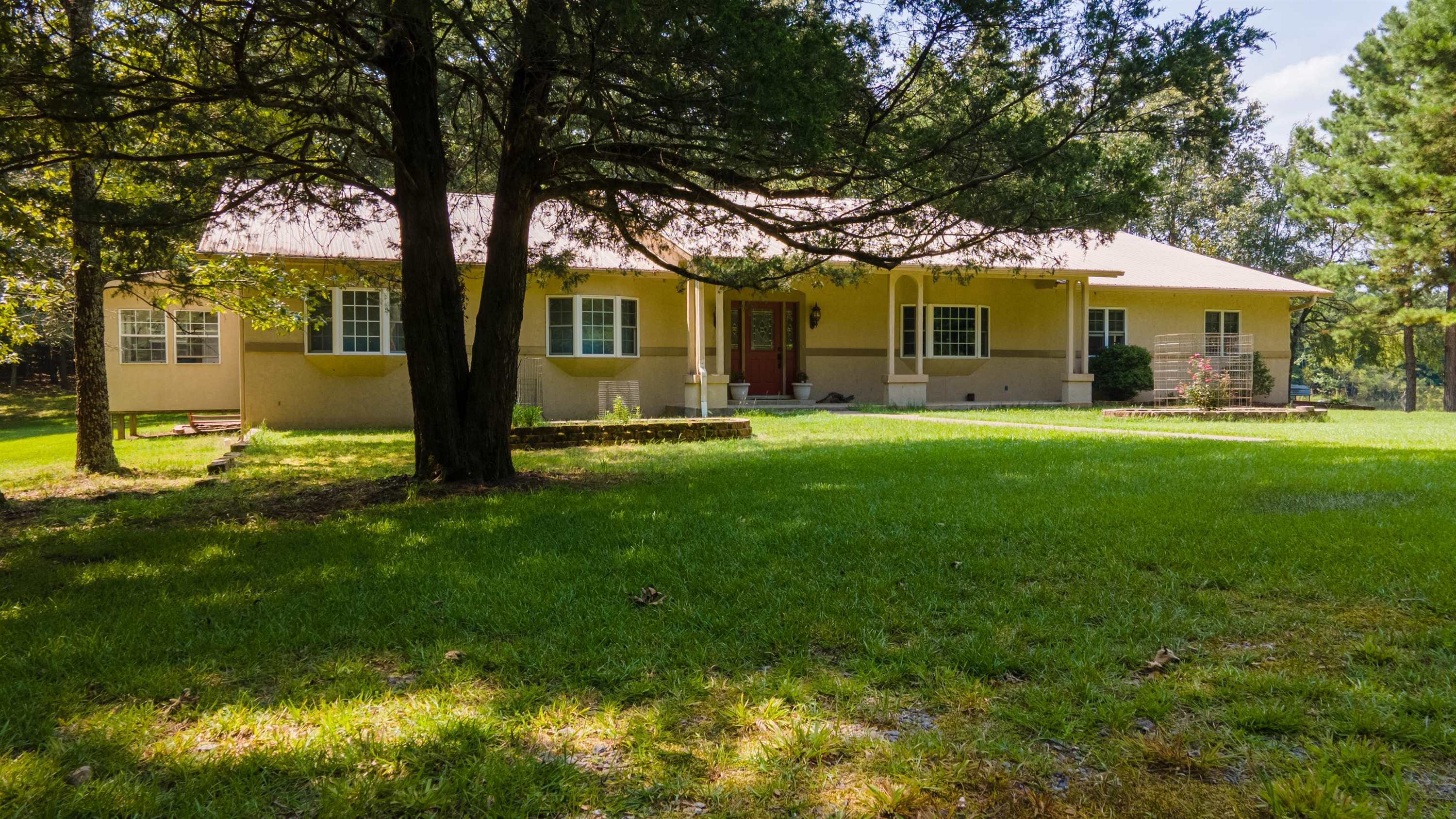 161 ac w/Alder Creek, Natl Forest on 3 sides and a lovely 3/2 home! Enjoy your own private lake, pond, garden, and deer that come up to your back patio. Pastures, woods, barn, workshop w/elec, RV shed w/power, trailer barn w/power, processing shed. Land is completely enclosed w/mostly electrical fencing. Thoughtful open floor plan, sun room, extra space in laundry for office, large garage, vaulted living rm ceiling, and generator. Crystals abound, deer blinds set up for hunting grounds, springs galore!