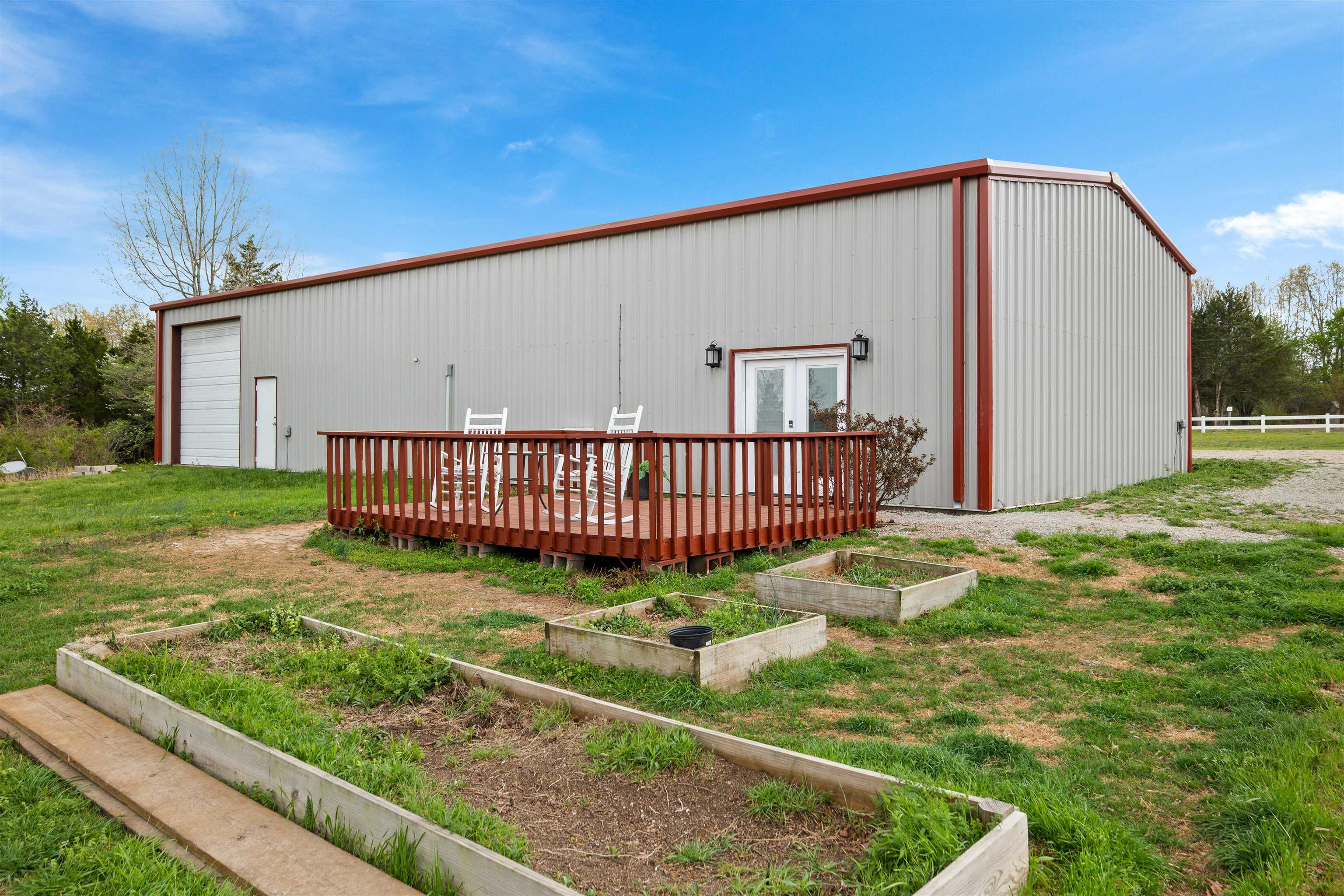 Versatile live/work opportunity on approximately 16 acres of half timber and half cleared land! This barndominium style property is ideal for those looking to combine business and residential living in one location. The 1,200 sq ft living area offers 2 bedrooms and 2 bathrooms, while the attached 1,200 sq ft workshop with CAR LIFT provide4s the perfect setup for a mechanic shop, hobby space or small business operation. Two additional outbuildings offer even more flexibility for storage, office space, or expansion. With plenty of room to grow and easy access, this property is well suited for entrepreneurs, tradespeople, or anyone seeking a functional workspace with living quarters on site.