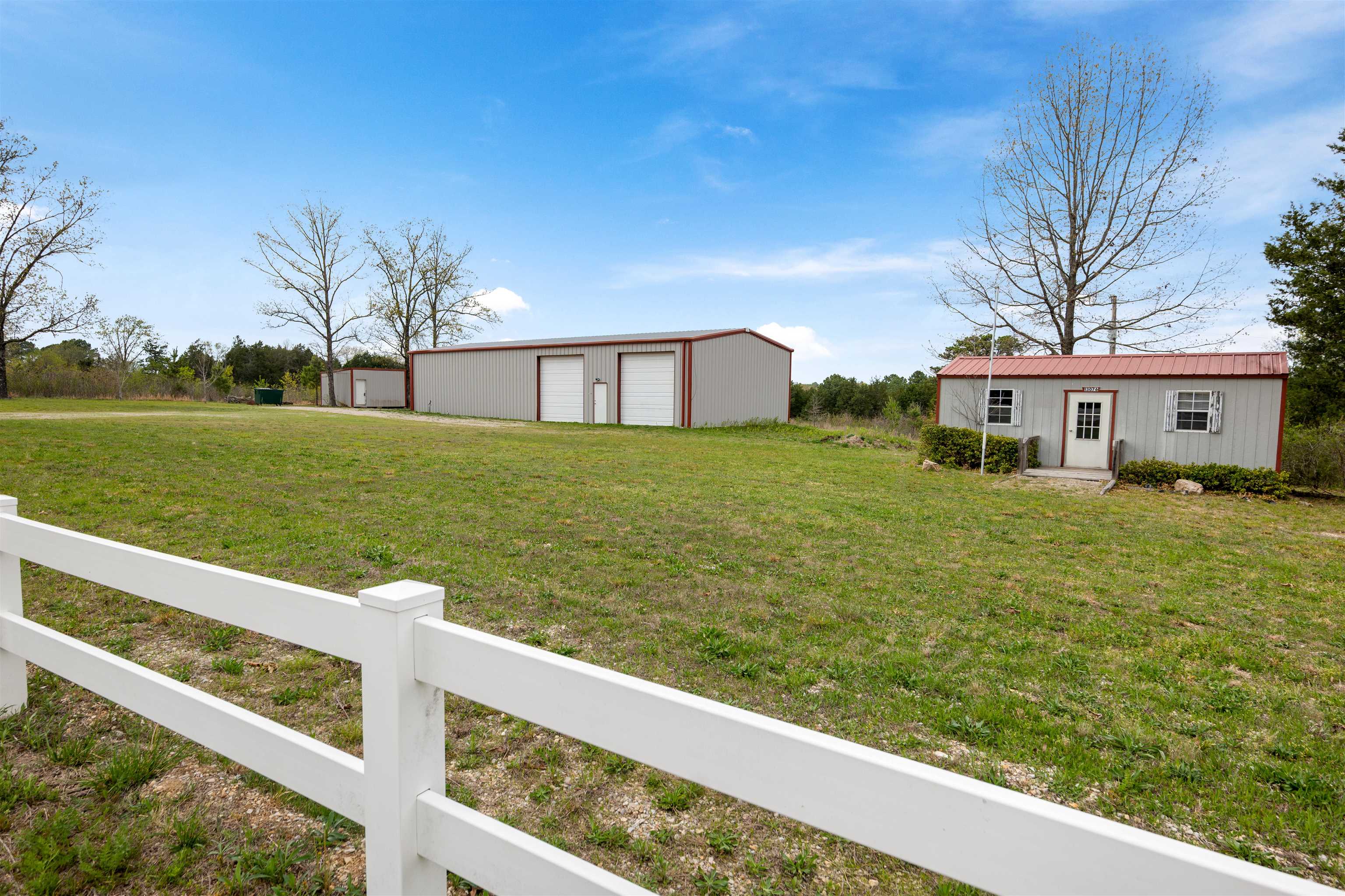 Versatile live/work opportunity on approximately 16 acres of half timber and half cleared land! This barndominium style property is ideal for those looking to combine business and residential living in one location. The 1,200 sq ft living area offers 2 bedrooms and 2 bathrooms, while the attached 1,200 sq ft workshop with CAR LIFT provide4s the perfect setup for a mechanic shop, hobby space or small business operation. Two additional outbuildings offer even more flexibility for storage, office space, or expansion. With plenty of room to grow and easy access, this property is well suited for entrepreneurs, tradespeople, or anyone seeking a functional workspace with living quarters on site.
