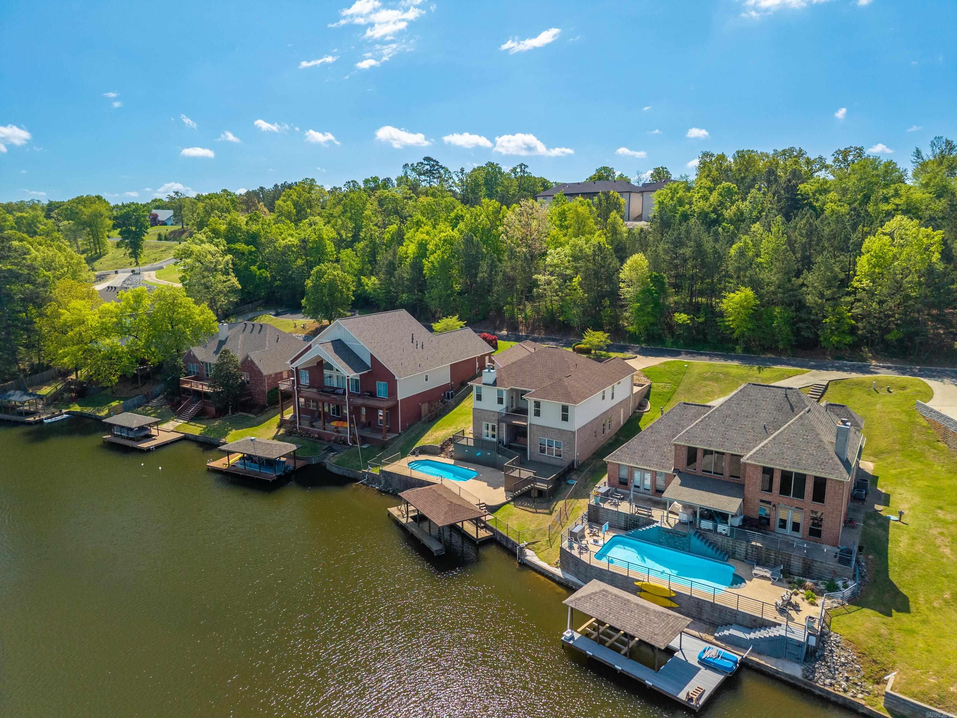Super nice home on quiet Lake Hamilton Cove. Lake living at its best. Fiberglass inground pool, hot tub, boat dock, established well maintained neighborhood. Large garage.... approximately 1079 sq. ft.