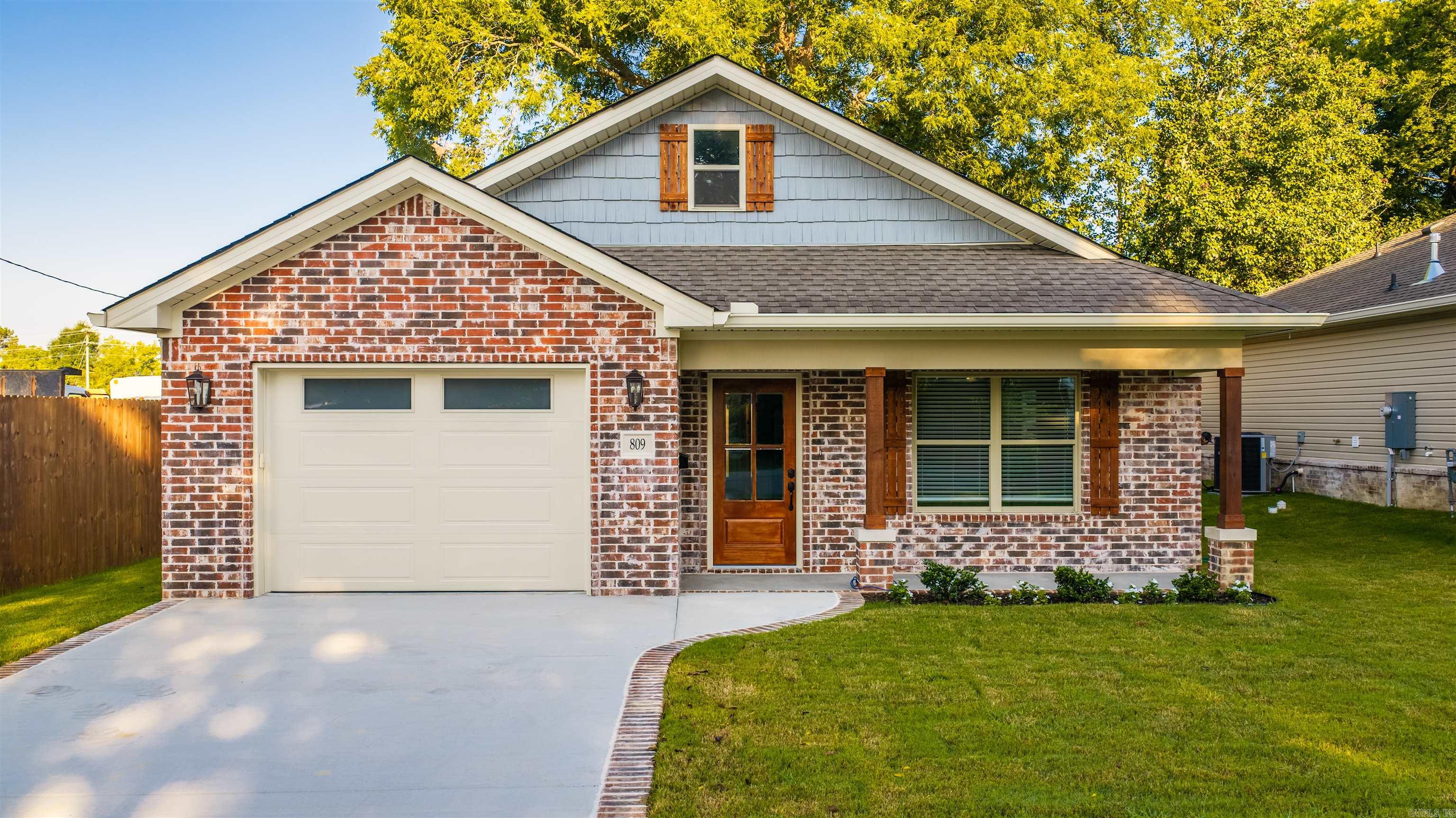 New Construction Home under $250,000? Yes! Details include -Brick on the front and sides, custom detailing on the front of home, LVP flooring, pretty cabinets with soft close, granite tops and tile back splash, floating shelves in the kitchen, there is even a charging station built into the bar. Stainless steel appliances including refrigerator and gas range, pantry, built in drop station, laundry room, primary suite has walk in shower, double vanity and good size closet, cove ceiling in the bedroom, vaulted ceiling in the living area, blinds throughout the home, fully fenced back yard, deck with built in bench, 1 car oversized garage with automatic door opener, extra details on the exterior including front porch with cedar posts, architectural roof and gutters. Walking distance to Ringgold School, a short bike ride to the Benton's Bike Park, and charming Downtown Benton with restaurants, and shops.  Taxes are on the lot.  805 and 809 have the same floor plan.