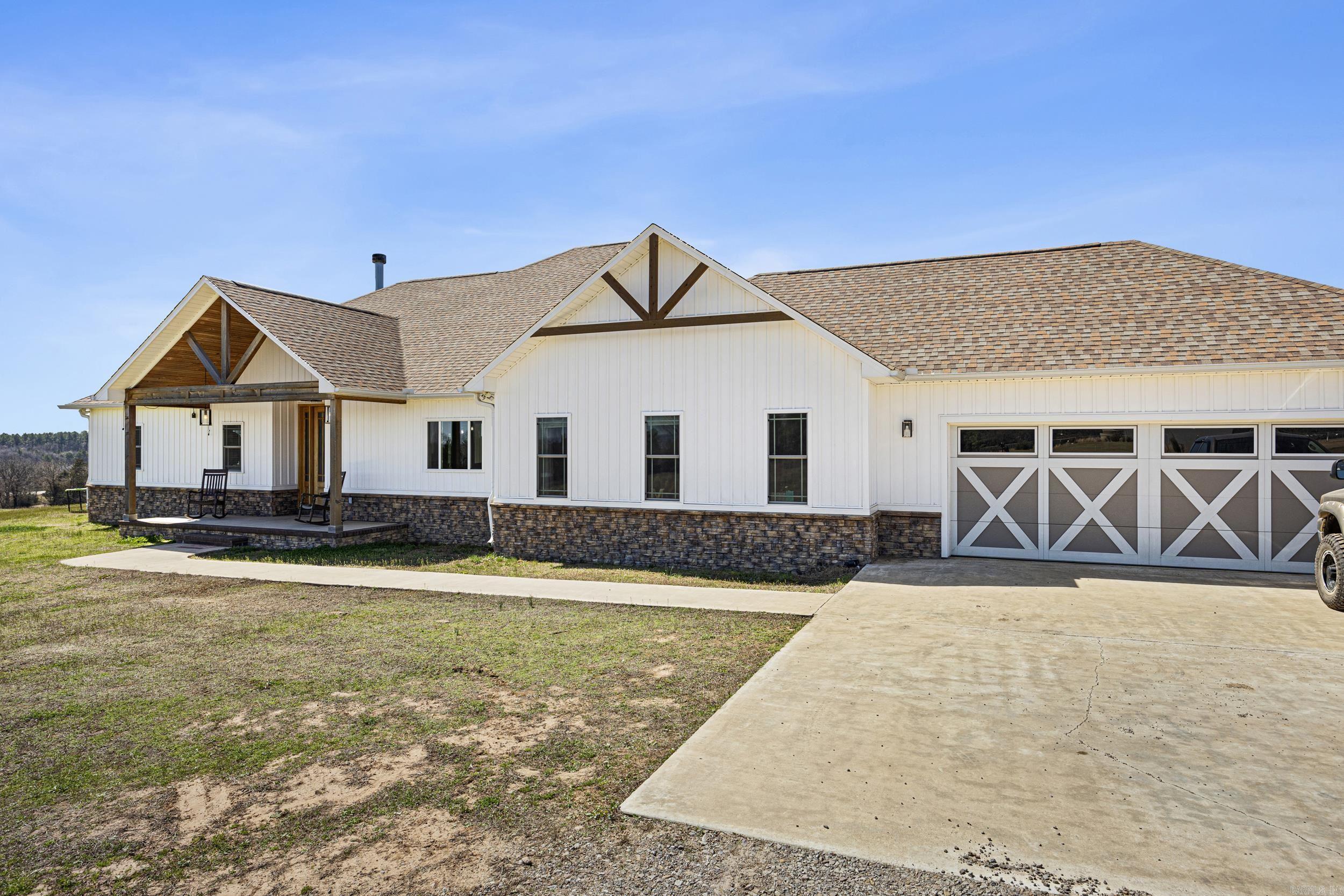 Dreaming of space, privacy, and land you can actually enjoy? This custom-built home on 30.83 acres is what you need! With a mix of open pastures and natural areas, there’s plenty of room to spread out, explore, and create the lifestyle you’ve been imagining. Built in 2021, the home thoughtfully blends modern comfort with a connection to the surrounding land. Inside, the 4-bedroom, 2.5-bath split floor plan is designed for both everyday living and entertaining. Soaring ceilings, an open layout, and quality finishes throughout make the space feel bright and welcoming. Outside, the 40x80 shop is perfect for hobbies, business, or equipment storage, and solar panels provide energy efficiency and long-term savings. Properties that combine a newer custom home, usable acreage, and functional infrastructure are hard to find. Located 15 minutes from Ozark and about 40 minutes from Fort Smith, this property offers the freedom of land ownership without giving up convenience - an ideal setting to live, work, and play.