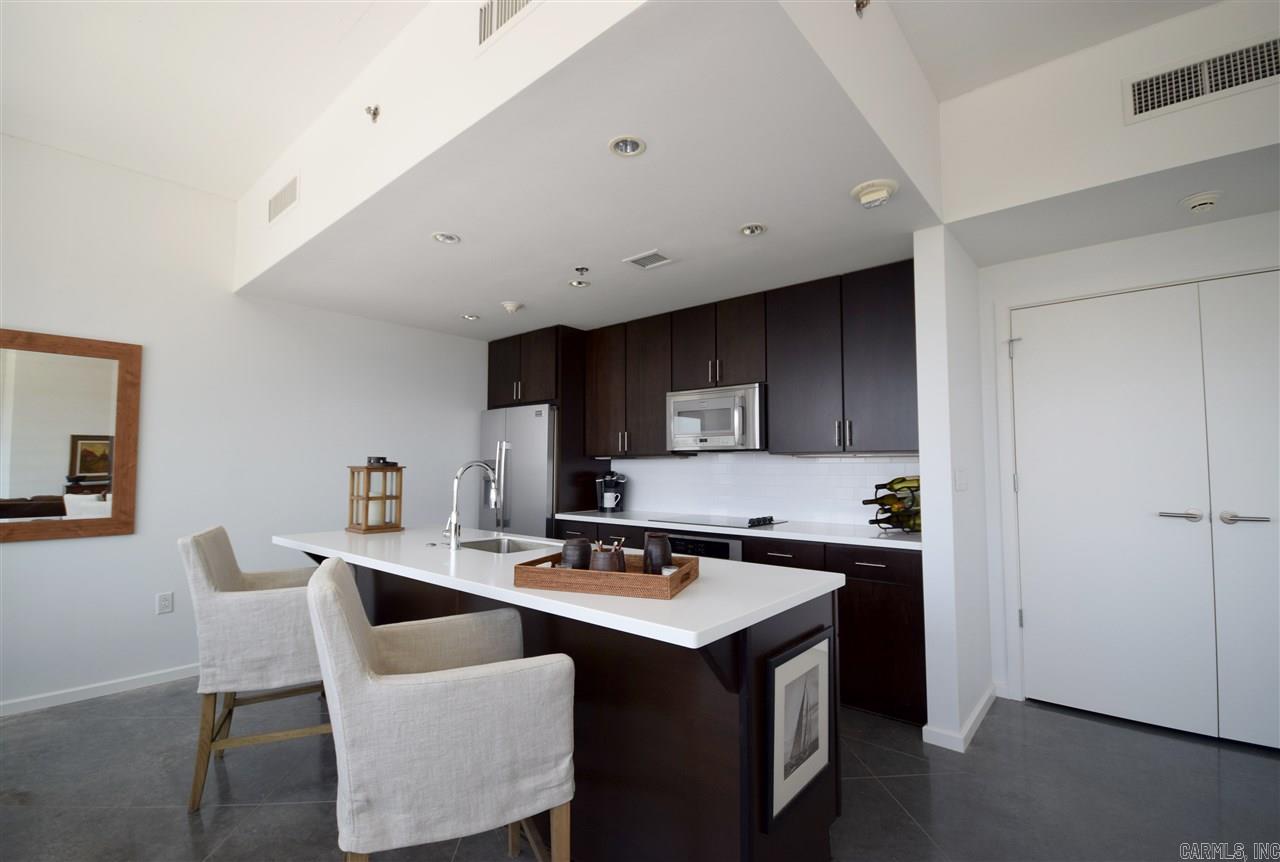 DEVELOPER OWNED UNIT! Black granite countertops, Stainless steel appliance package. Floors are scored concrete. Ceilings are exposed concrete.  Private, covered balcony off of living area!  Located in the heart of the River Market District within walking distance of area restaurants, bars, galleries and shops.   Swimming pool, fitness center, tennis and basketball courts, rooftop deck and party room and concierge service included. Two reserved parking spaces.    See www.rivermarkettower.com