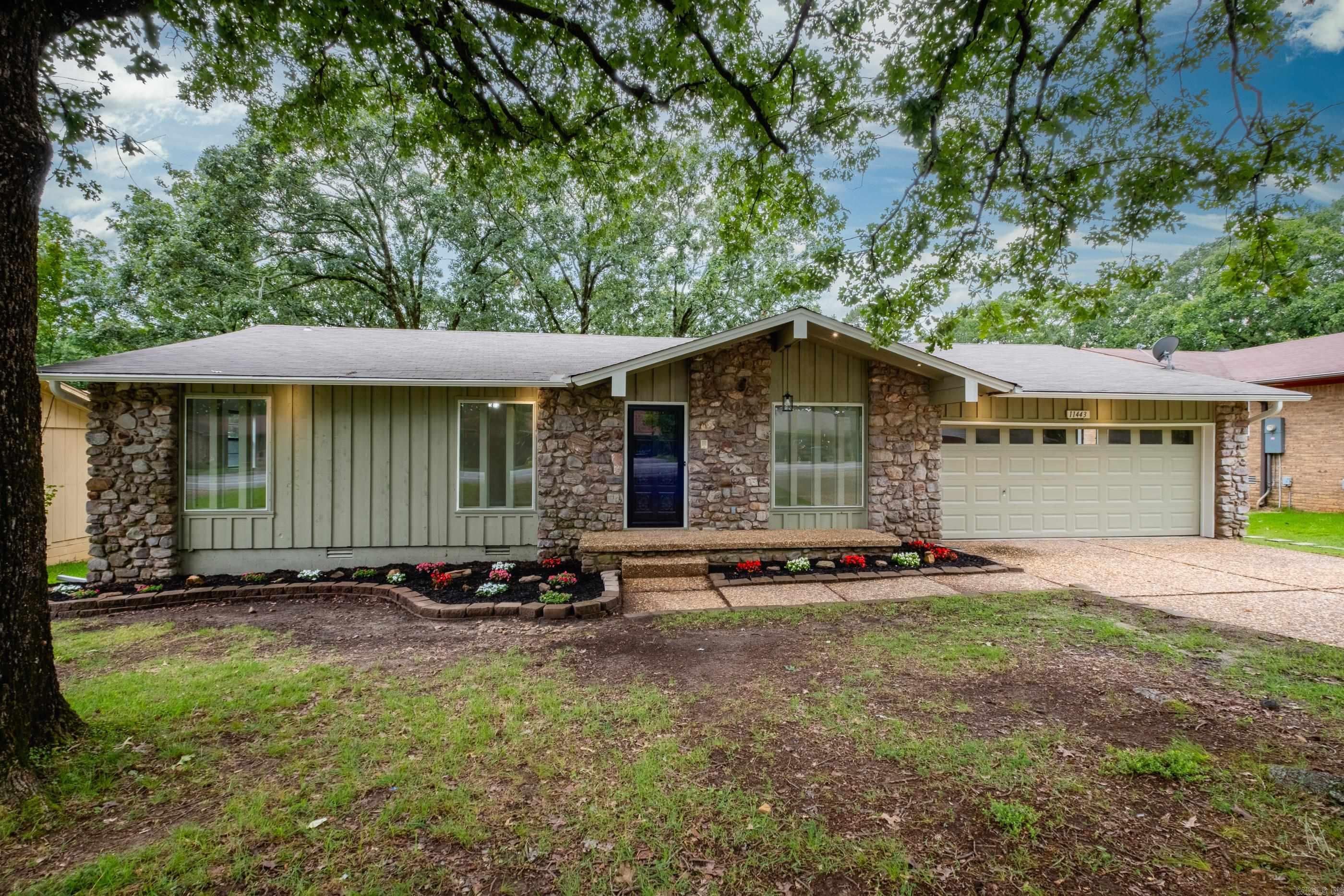 Welcome to 11443 Southridge Rd, where modern comfort meets established charm in a convenient WLR neighborhood! If you crave the character of a mature neighborhood without sacrificing the pristine feel of a new build, this home is for you. Step inside to a "like-new" interior featuring fresh paint, plush new carpet, and beautiful new tile flooring. The thoughtful floorplan offers plenty of room to spread out with both a welcoming front living room and a massive central family room with vaulted beam ceilings. Entertaining is easy with a well-proportioned kitchen and dining room combo.  Just off the kitchen is a remarkably large laundry room outfitted with extra storage cabinetry, pantry space and sink. The home features a private primary bedroom suite with a double vanity bathroom, plus two additional well-sized bedrooms sharing the 2nd full bath. Step out back onto your expansive deck overlooking a serene, fully fenced, wooded backyard. Zoned for the highly desired Don Roberts School district and perfectly positioned for quick access to Cantrell Road and I-430, this incredible home won't last long!