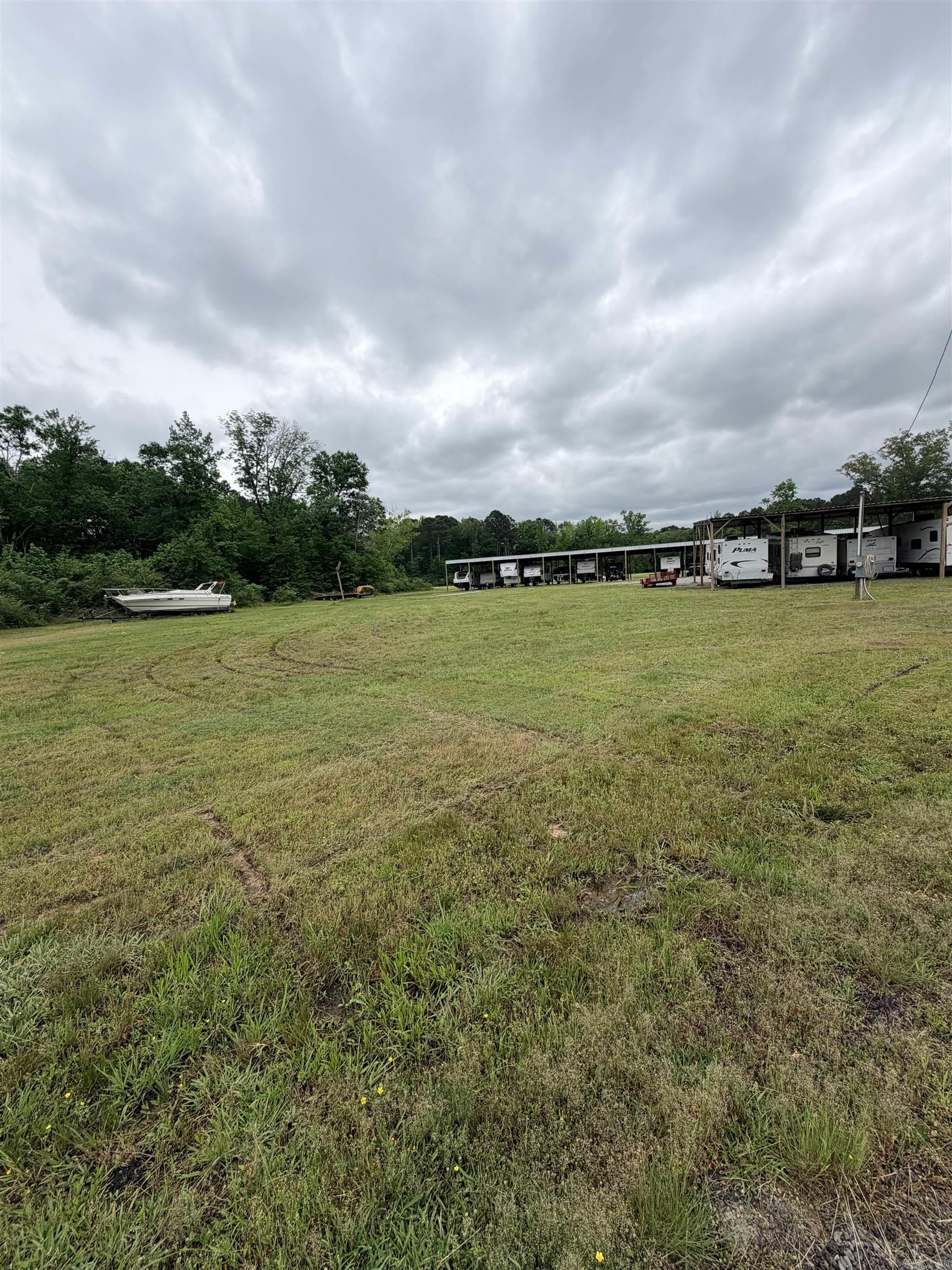 Don't miss your opportunity to own this awesome mini storage and boat/RV storage facility located in the rapidly growing community of Haskell, AR. This fenced and gated property sits on five plus acres and currently has 40 10x10 storage units and 31 covered units for RV and boat storage. The remainder of the five acres is cleared and there is ample room to add more RV storage units. Taxes are estimated as they are currently included with other property at this time. Over 18,000 sq/ft of either mini storage or covered RV storage. No sign located at the property. A portion of the property is in the flood zone. Not the area where the storage units are. Look for the J&C Sign.