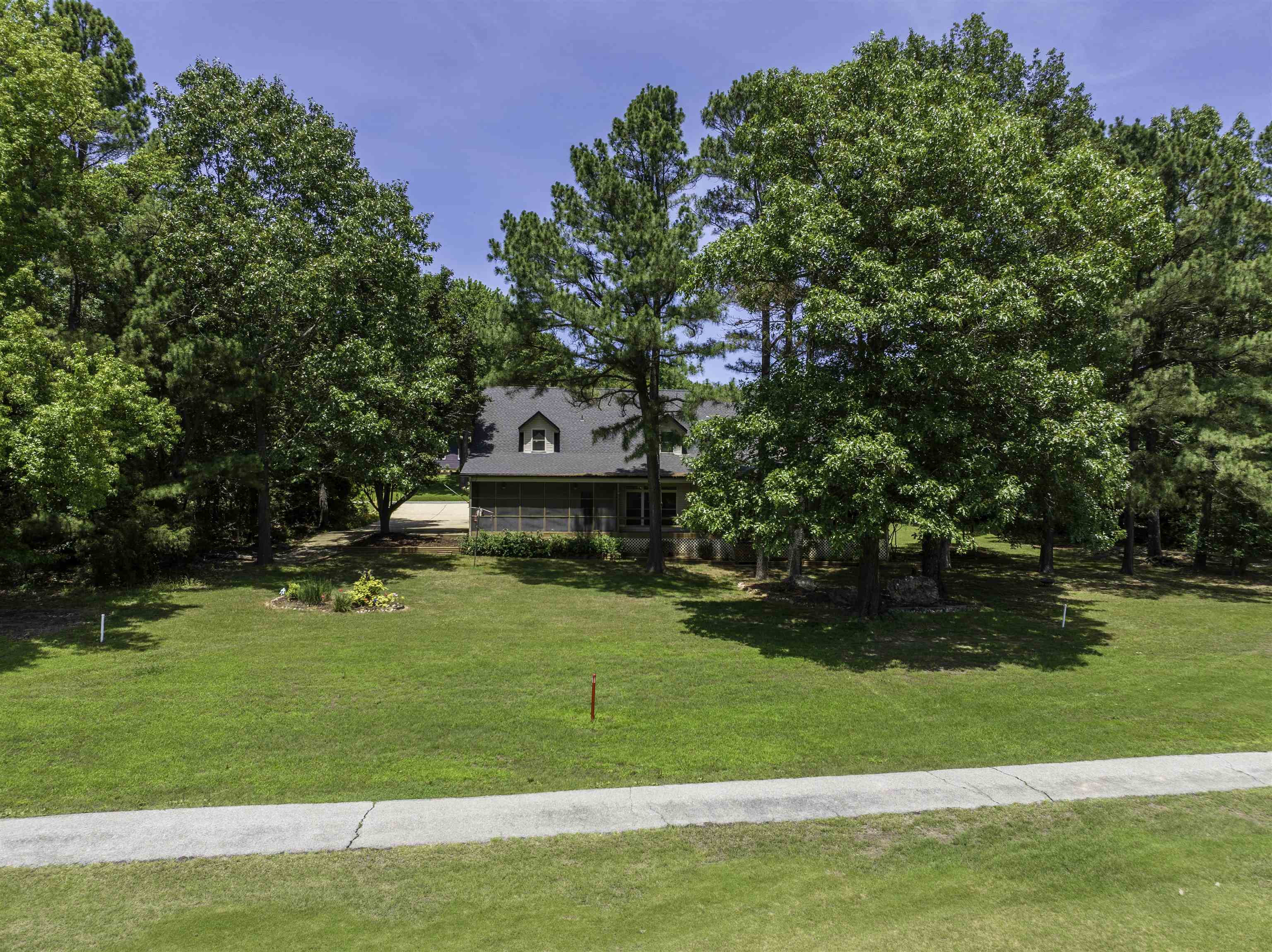 Custom-built brick golf-course home on 17th fairway of South Course! Tons of natural light w/full length & transom windows. Main level boasts spacious living room w/vaulted ceilings & hardwood floors. Updated, open kitchen featuring tons of cabinets, Corian countertops & large pantry. Eat in breakfast nook w/outside views or use separate dining room. Updated appliances '25: Fridge, dbl oven, dishwasher; all incl in list price w/vented caran cooktop & microwave. Generous utility room w/2nd fridge. Beautiful custom hardwood flooring refinished in 2024 & Amish-crafted crown molding/trim throughout. 36-inch wide doorways offer enhanced accessibility. Unwind on screened-in porch-perfect for peaceful mornings & relaxing evenings. Primary suite connects to luxurious bath featuring heated jetted tub, walk-in shower, walk-in closet & dual vanities. Upstairs-3 addl bedrooms & full bath. Major updates offer peace of mind incl roof 2023, HVAC system 25/21, interior paint, gutters/downspouts/fascia 2023 & skylight. Oversized 3 car garage w/shop-auto door openers. Only 2 owners of this home. 1 level living possible w/2 bdrms & laundry/kitchen on main level. Don’t miss this Cherokee Village gem!