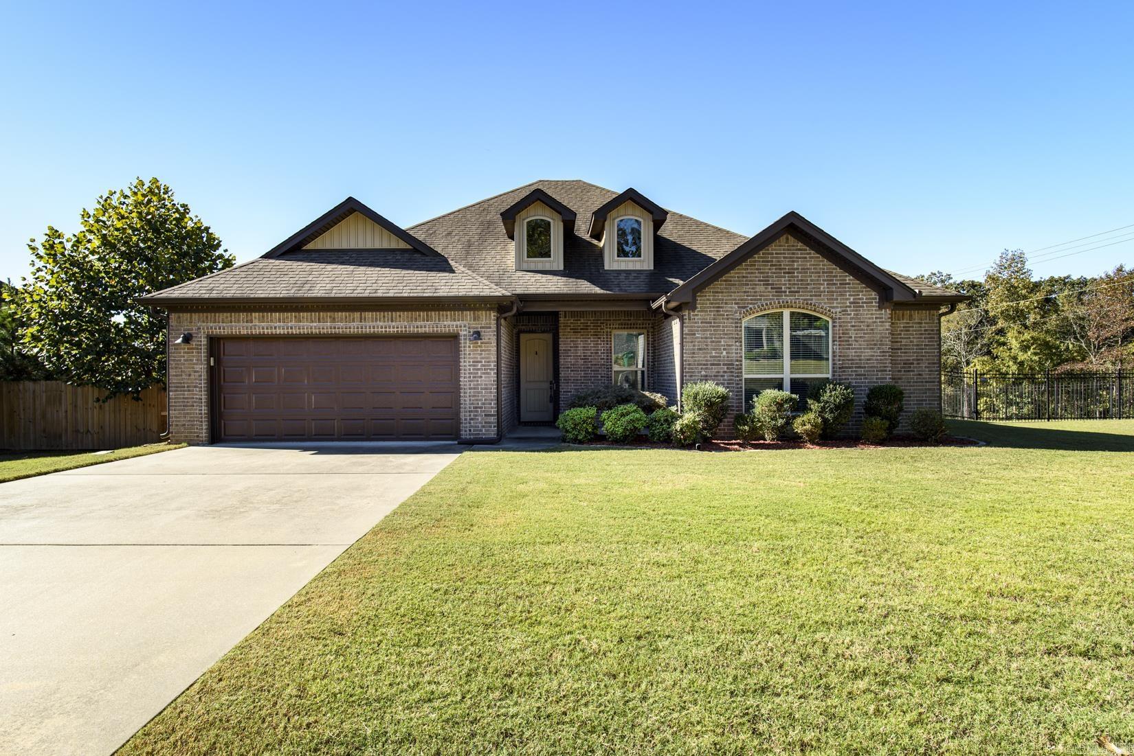 Fabulous One-Level Home in Lochridge Estates! Welcome to this beautiful 4-bedroom home located in the gated community of Lochridge Estates in West Little Rock. This one-level home offers an inviting open layout and timeless finishes throughout. The spacious great room features a cozy gas log fireplace and flows seamlessly into the gorgeous kitchen, complete with granite countertops, stainless steel appliances, a gas cooktop/stove, breakfast bar, and a generous breakfast area—perfect for casual dining.The primary suite is a relaxing retreat showcasing a wood tray ceiling, walk-in closet, jetted tub, an d a separate shower. Three additional bedrooms provide plenty of space for family, guests, or a home office.  Step outside to enjoy a covered patio and open deck overlooking the large, fenced backyard—ideal for entertaining or simply taking in the peaceful surroundings.  Agents please see remarks.