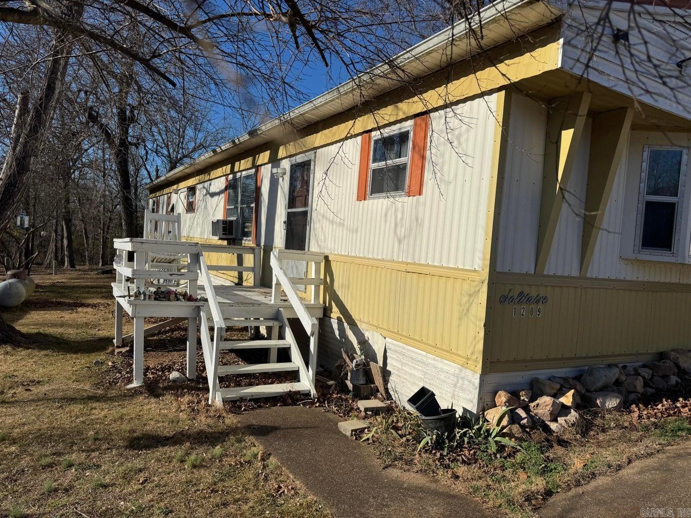 Experience park-like living in this well-maintained 2-bedroom, 2-bath manufactured home set on almost an acre. Step inside to a welcoming living room with brand-new flooring (and extra materials ready to complete the look). The home features a cozy wood stove for those cool evenings, along with a wall-mounted gas heater for reliable backup warmth. The spacious kitchen boasts new appliances, ample cabinetry, and a reverse osmosis water system for fresh, clean drinking water. You'll love the dedicated laundry area, thoughtfully designed for practicality, and the home's exceptionally low utility bills, thanks to energy-efficient systems. The property includes two outbuildings—ideal for storage, hobbies, or a workshop