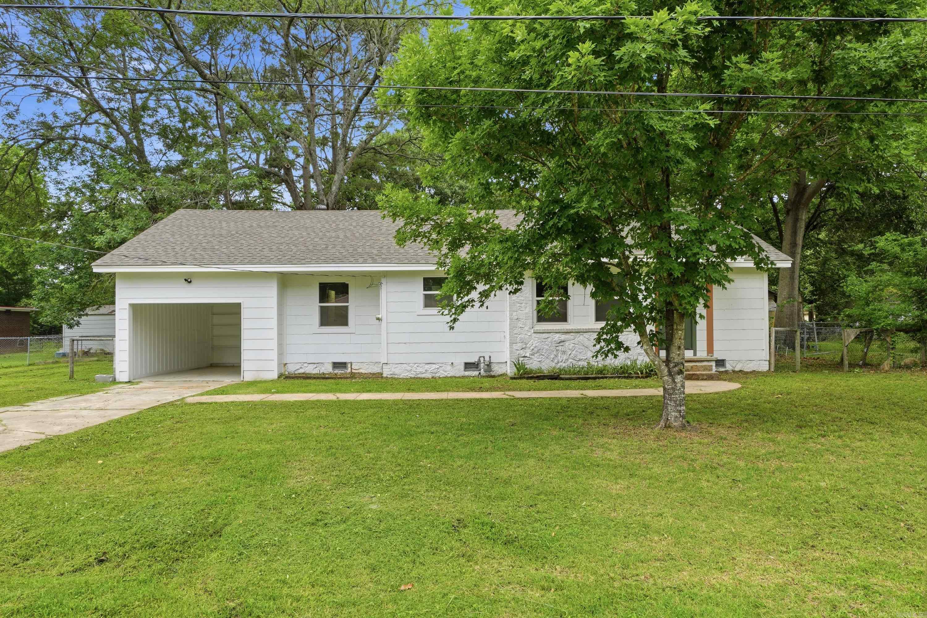 Beautifully renovated 3 bed 2 bath home with all new flooring, paint, countertops, windows, and much more.  Custom details throughout give this home a craftsman vibe on the inside. The kitchen and bathrooms feature granite countertops. Easy to maintain vinyl floors throughout. The separate dining room can also be used as an office or bonus room. Large back yard with mature shade trees and an existing outbuilding that could be restored. Situated in the heart of Kensett, this home provides easy access to Searcy, while maintaining a small town feel. Schedule your showing today. Some photos are virtually staged.
