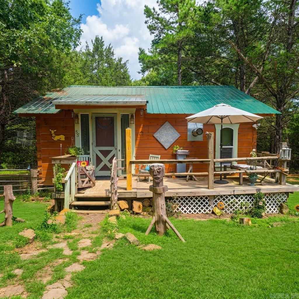 Are you looking for a peaceful, private retreat complete with some pasture perfect for your homestead and wooded space with trails to explore? And all within minutes of Wooley Hollow State Park?! Look no further!   This charming cabin sits on 5 acres with several additional structures. The primary cabin offers warmth and open spaces with vaulted ceilings, rustic wood finishes, and a studio-style layout! There is a large dining and living room area, a galley-style kitchen, a bedroom space with a walk-in closet, and a shared bathroom/laundry room.   There is an additional 1-bed, 1-bath apartment with a small kitchen and living room above the detached garage. An additional barn structure near the house was once used for a very large chicken coop. And in the pasture, the metal barn/shop is complete with a concrete floor, electricity, and a couple of stalls ready for your livestock.   Behind the house, you will find a wooded area where significant work has been done to clear underbrush and create wonderful trails perfect for exploring nature in your own backyard!