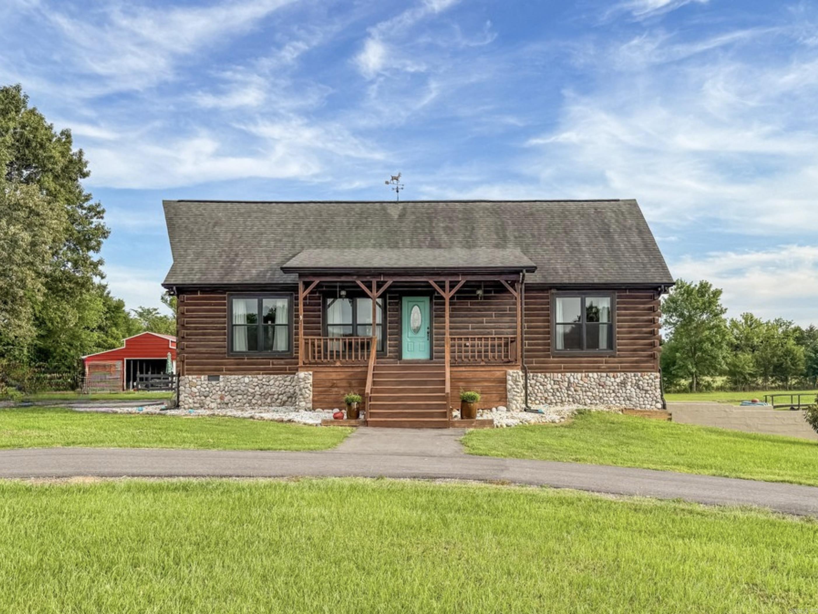 Beautiful log home sitting on approx. 5 acres fenced in with custom automatic gate. 3 bedrooms/3 baths. 2,404 sq. ft. Granite countertops. Custom wood details throughout. Pine ceilings and recently installed walnut floors. Pella fiberglass windows. Tile floor in utility room and cork flooring in basement level. Propane fireplace. Custom lighting. Two vented skylights lights in loft bedrooms. Two wall mounted Dyson vacuums. Whole house propane generator with transfer switch. Both propane tanks will transfer to buyer. In ground sport pool with multicolored in-pool lighting. Pool furniture included. 30 X 36 metal barn. 1,200 sq. ft. log siding shop with HVAC and 220 wiring. SEE REMARKS