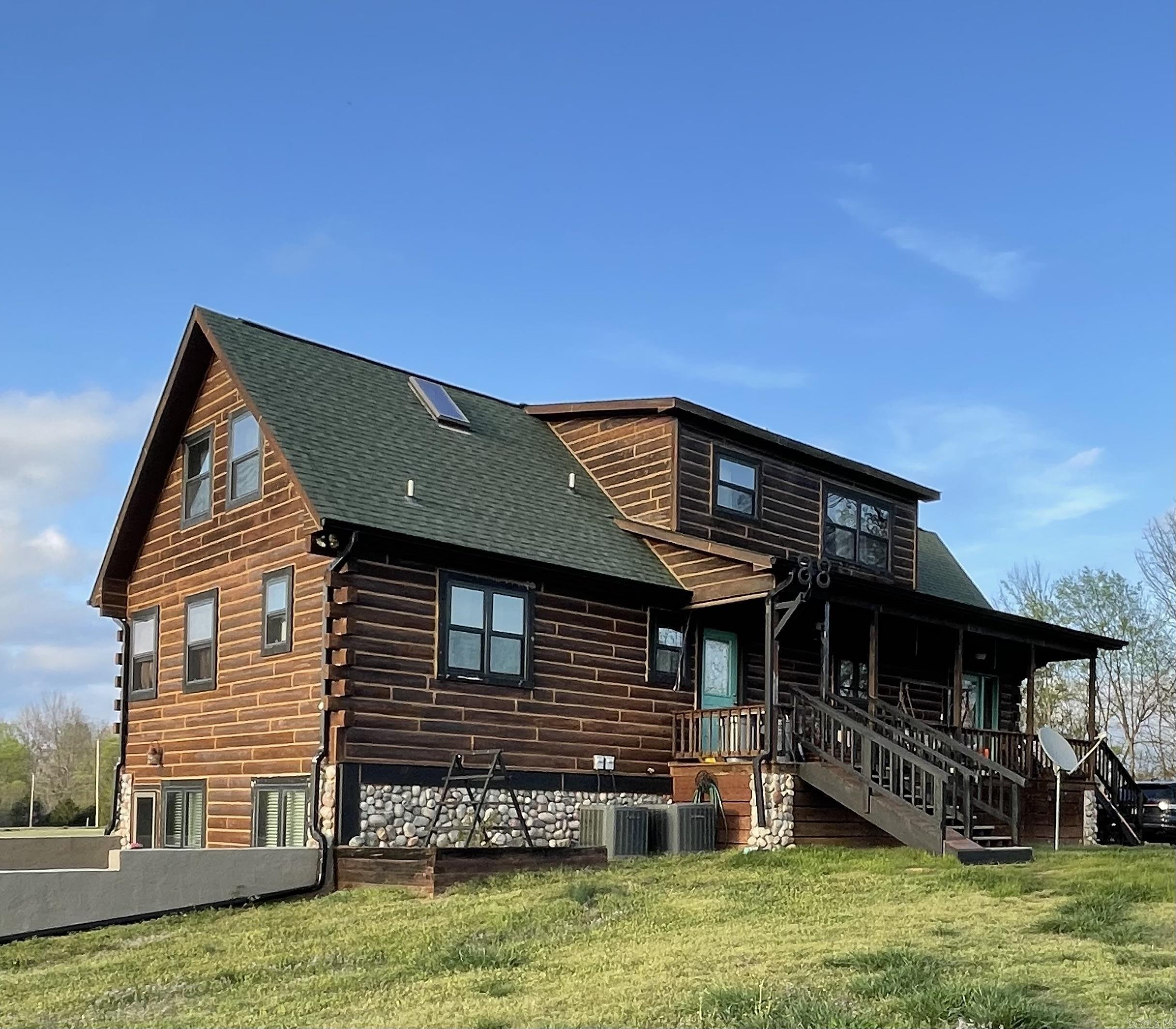 Beautiful log home sitting on approx. 5 acres fenced in with custom automatic gate. 3 bedrooms/3 baths. 2,404 sq. ft. Granite countertops. Custom wood details throughout. Pine ceilings and recently installed refinished walnut floors. Pella fiberglass windows. Tile floor in utility room and cork flooring in basement level. Propane fireplace. Custom lighting. Two vented skylights lights in loft bedrooms. Two wall mounted Dyson vacuums. Whole house propane generator with transfer switch. Both propane tanks will transfer to buyer. In ground sport pool with multicolored in-pool lighting. Pool furniture included. 30 X 36 metal barn. 1,200 sq. ft. log siding shop with HVAC and 220 wiring. SEE REMARKS