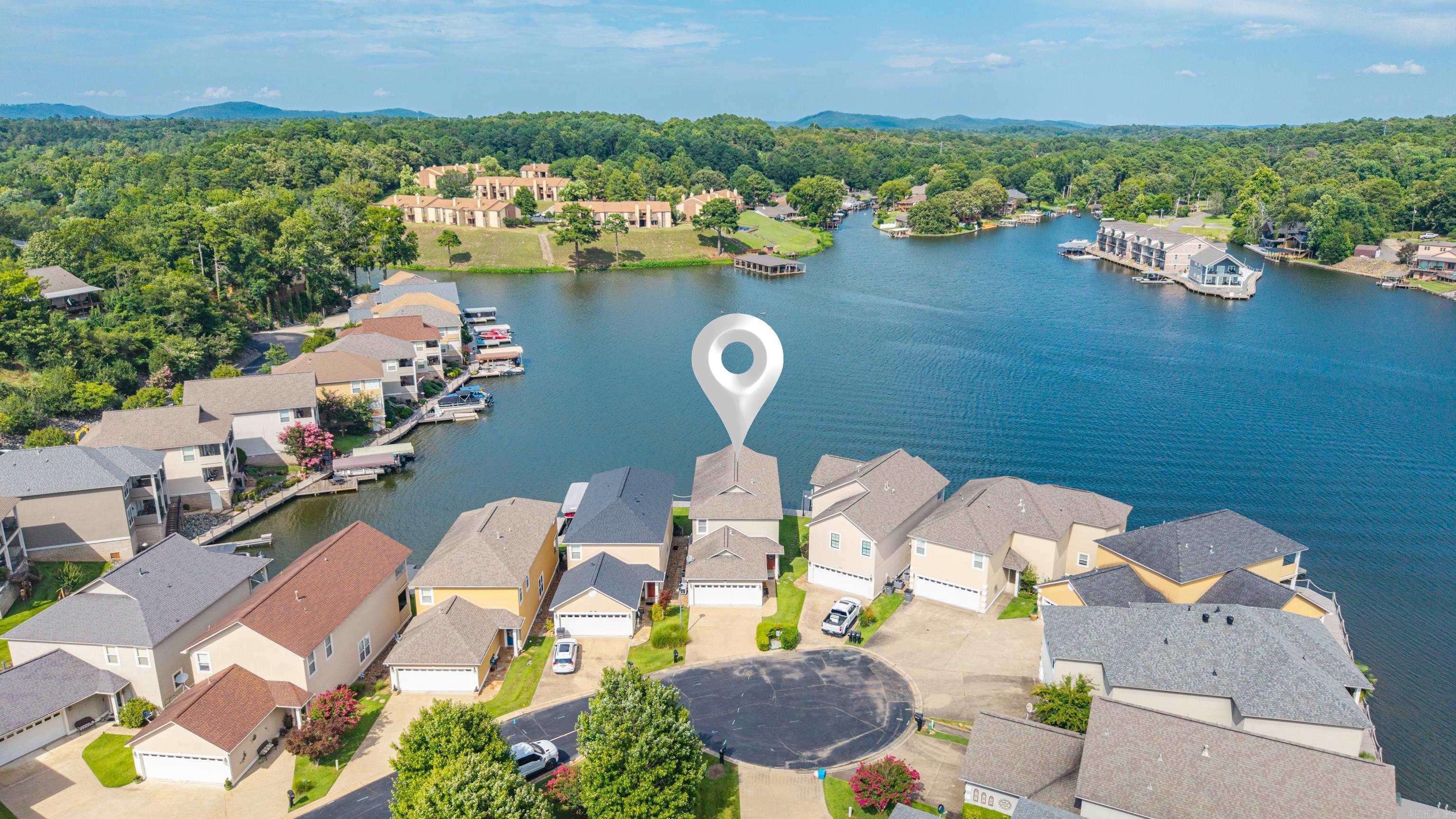 MODERN LUXURY MEETS LAKEFRONT PERFECTION! Welcome to your ulitmate waterfront sanctuary.  Nestled in one of the area's most sought after and convenient locations, this stunning lakefront home has been meticulously reimagined and updated to offer contemporary luxury and relaxed lakefront living. On the interior, you will find two expansive Primary suites, one on the main level and one upstairs with spa like ensuites and massive walk in closets.  Enjoy an open concept with modern fixtures, engineered hardwood floors, and a chef's kitchen equipped with premium quartz countertops, high end stainless steel appliances, and a six burner gas cooktop.  In addition to the exquisite interior,  you also have two balconies complete with porch swings and a lakeside boat dock and deck. Also has Generator.  Waterfront properties of this caliber, featuring dual primary suites and modern updates in this specific location, are exceptionally rare.  Dont miss this chance to own this slice of lakefront paradise.  Schedule your private tour today and prepare to fall in love.