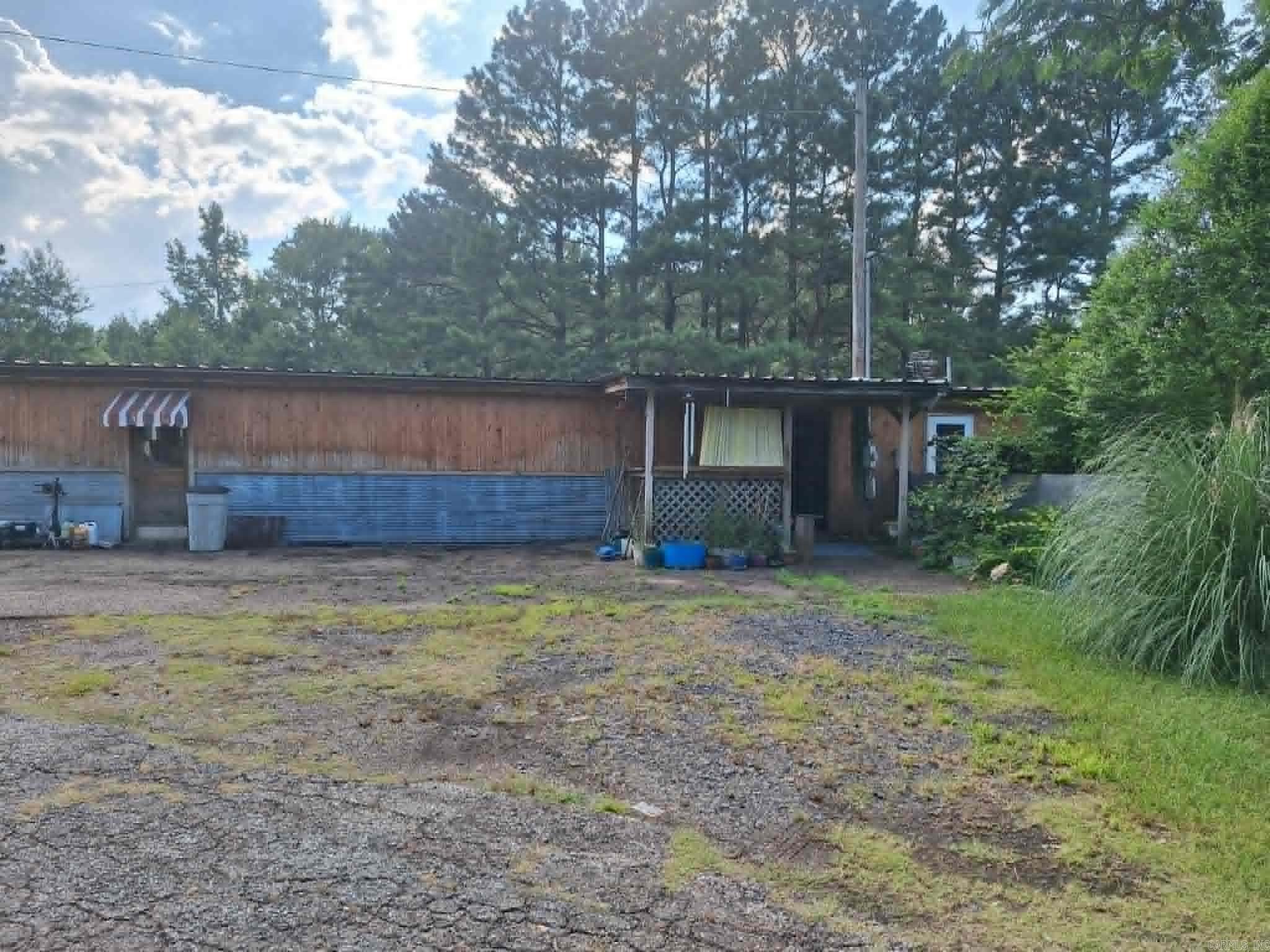 Possibilities are endless! This home has a shop on the front that can be for any business you can think of. Shop doors on the front of this building allow for vehicles to be pulled in. Highway Frontage with Hwy 71 on one side of the property along with a county road on the other side. The inside features a retro kitchen with an open concept to the living room. Two bedrooms with an office in the middle are at the back of the home.  The large backyard could be the perfect spot to build!