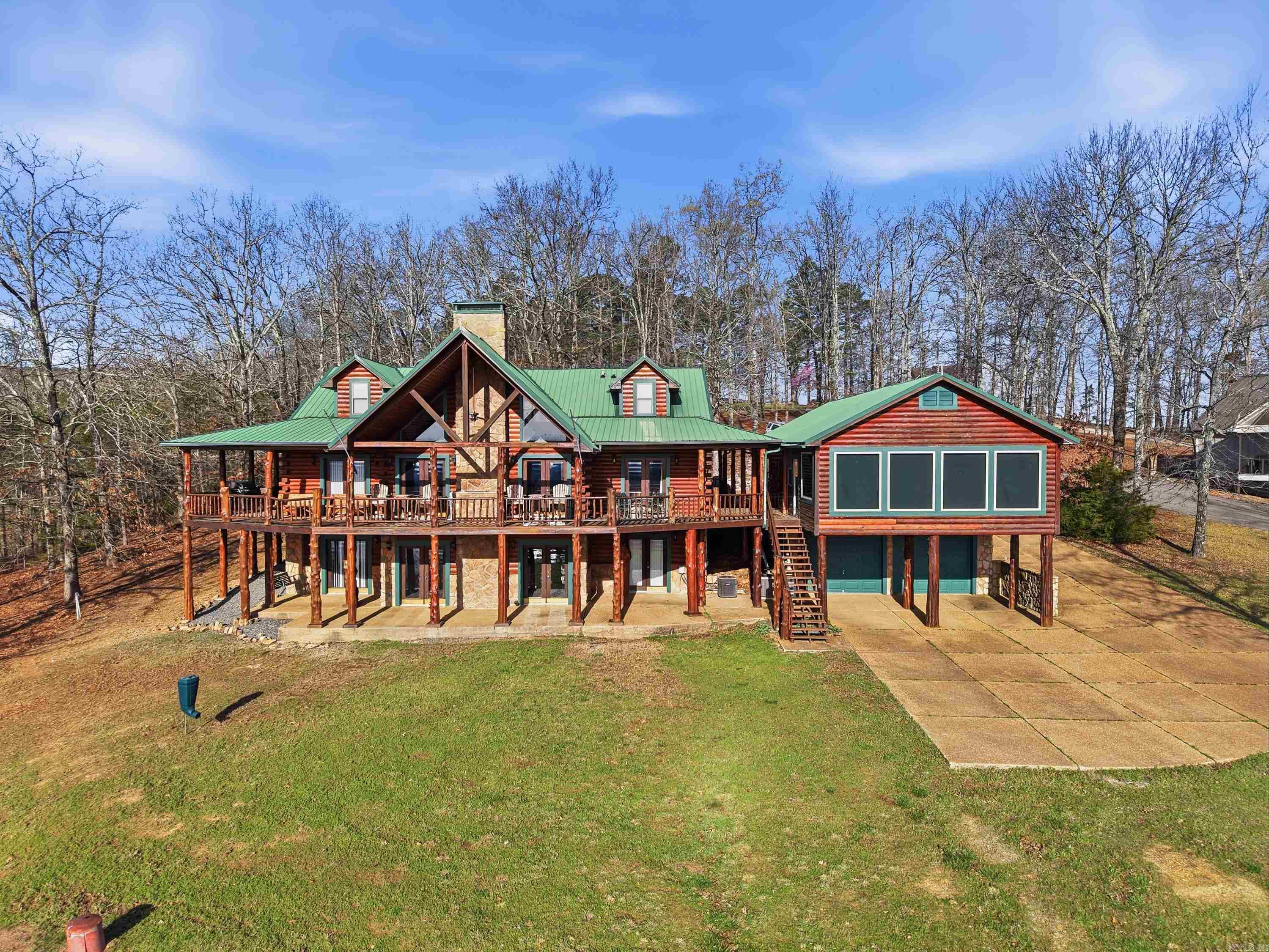 TWO BOAT SLIPS (2 boat lifts), STUNNING VIEWS OF Greers Ferry Lake, & 2.32 acres! This Log Home has 4,824sqft. plus a separate Sunroom that has 384sqft. heated & cooled. 2-car garage on the front of home & 2 Rear Entry garages for your lake toys. Walk right into the Mud room after playing on the lake all day where you can drop your bags & unwind for the evening. This home was designed to have plenty of room for your family & friends to sleep comfortably, but also extra space to spread out and entertain in the living rooms, gameroom, sunroom, deck, or the large backyard (which all have Views of the Lake while doing so). Comes fully furnished (except for the gaming items & a few other items noted in the home that do not stay). There is zoned parking for the Community Boat Dock that makes it easy to park your car or SXS & walk down to your boat slips. Also, FFB ATV trails are not far from Watersedge so you can leave the lodge & go straight to the trails or golfing at Indian Hills & Mountain Ranch Golf Courses. (See realtor remarks with details on which two slips are included). See Link for more pictures, virtual tour, etc. under "virtual tour".
