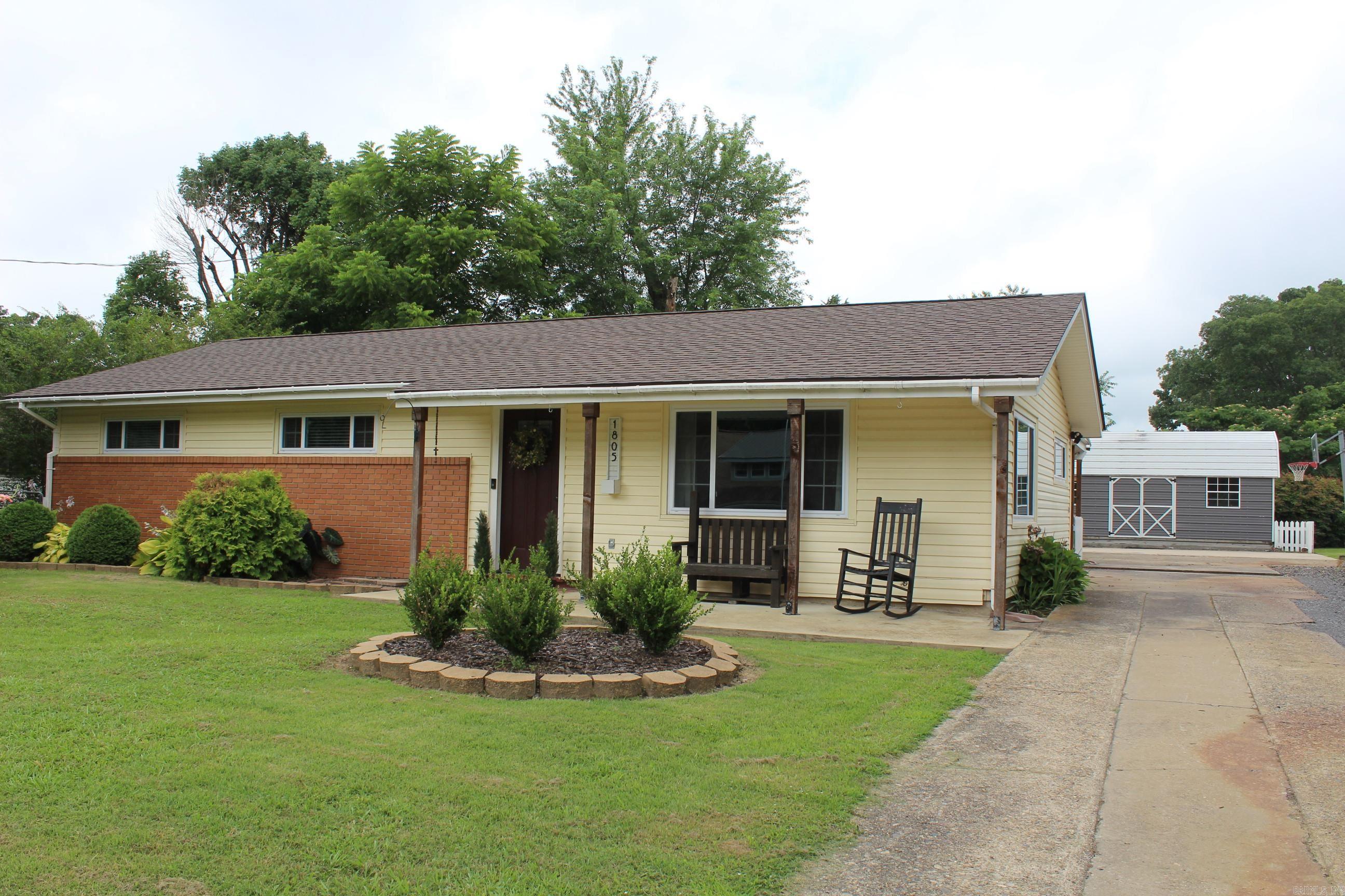 Adorable.. Beautiful..updated.. neat.. clean.. well-arranged modern.. stainless appliances.. stunning brick focal point wall with gas log fireplace in spacious living area. 3 nice sized bedrooms, Beautiful upscale bathroom with large walk-in tile shower. New roof 5/2026. Covered back patio. Beautiful yard with extra landscaping. Storage building.