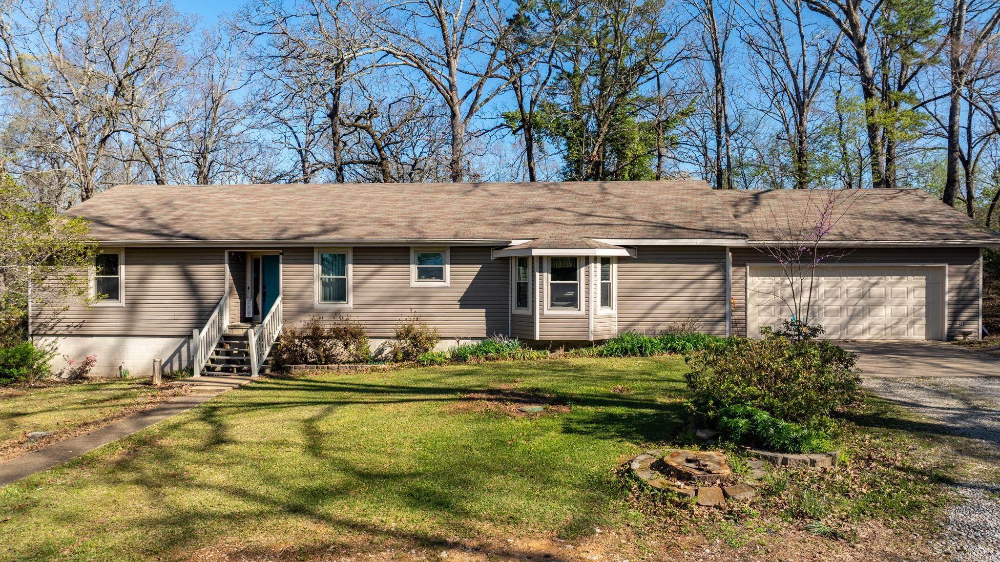 Nestled on 4.88 acres, this versatile property offers the perfect blend of comfort, functionality, and space for both everyday living and hobby use.  3-bedroom, 2 bath home features a spacious layout with an office, additional living area, and a mud room for added convenience. The primary suite includes a walk-in shower. The kitchen is well-equipped with abundant cabinetry, a pantry cabinet, Jenn-Air range, and a dishwasher that is just one year old. A cozy new Buck fireplace insert adds warmth to the main living space.  Outdoor features truly set this property apart. Enjoy a 24x24 covered deck , along with a greenhouse that conveys. The property is partially fenced, including a dedicated dog area and a newly installed privacy fence section. Plenty of workspace or storage, the property includes a 30x60 metal building, a 20x30 barn with three stalls and a tack/feed room, and an oversized two-car garage. Secure storage/shop/safe area located beneath the home. Equipped for RVs and preparedness, you'll find a 50-amp RV hookup at the end of the house, a 30-amp hookup at the barn, and a generator hookup. The septic system has been recently pumped, inspected, and update.