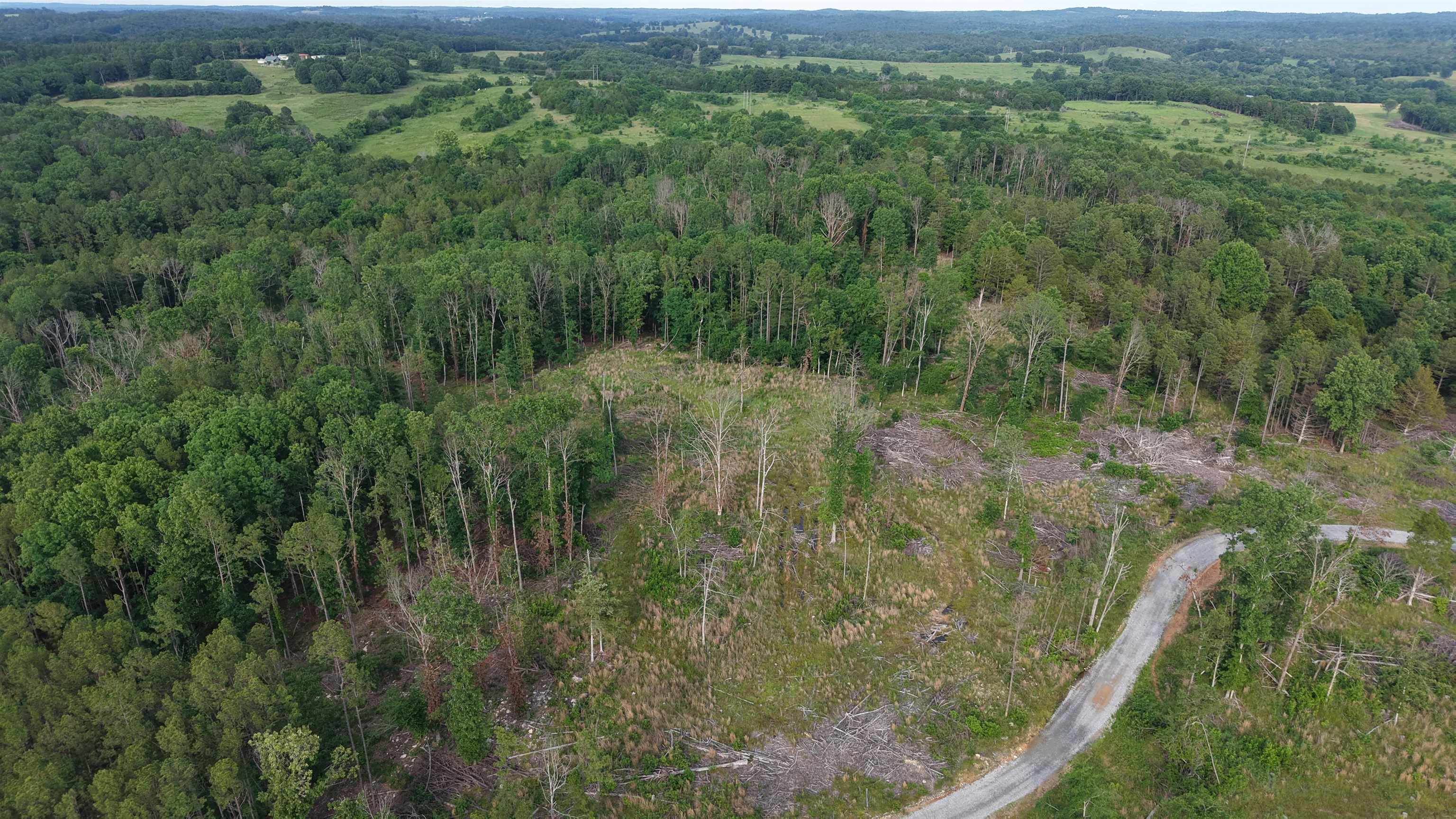 This unrestricted 25.5 +/- acres in Elizabeth, Arkansas is located on a private road near Norfork Lake. The tract is surveyed and offers multiple building sites, ideal for a full-time home, cabin, or recreational getaway. Electric is available near the property, and the land features a gated entrance for added privacy and controlled access.  This area is known for excellent hunting and outdoor recreation, offering a mix of timber, wildlife habitat, and nearby lake activities.  Offering an outstanding opportunity for hunting land, recreational use, or long-term investment, this acreage is priced affordably at only $89,500. Additional adjoining acreage is available for buyers seeking a larger tract.