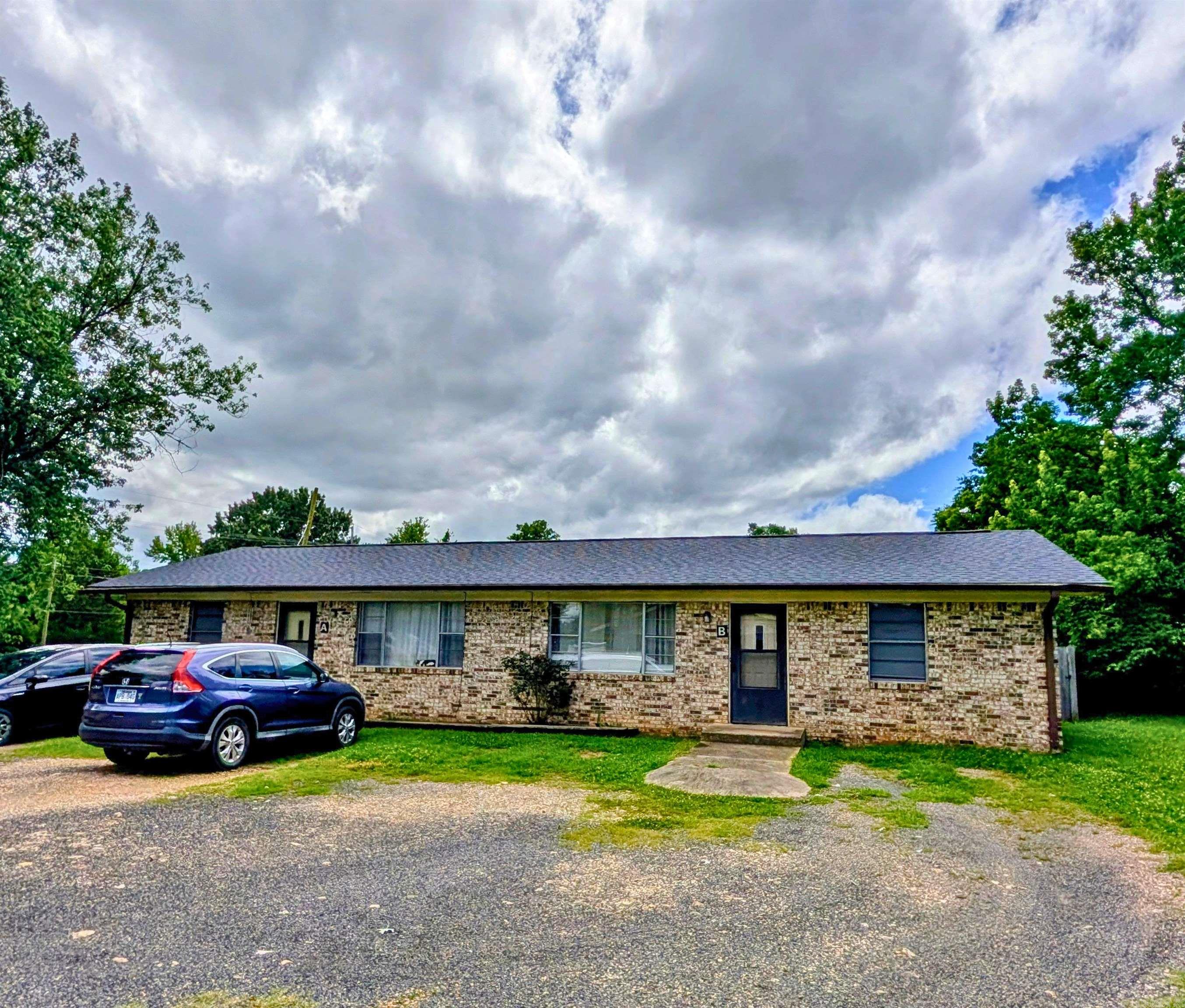 Income-Producing Duplex with Expansion Potential.  This property sits on an oversized, spacious lot with city utility access.  Great Location. Just blocks from downtown, each well-kept unit features 2 bedrooms, 1 bathroom, are currently rented and has an excellent occupancy rate.  Large, pretty lot, privacy fenced with separate smaller privacy fenced back yards.  This large footprint provides incredible potential for future expansion, a workshop, or adding accessory structures. Perfect for seasoned investors looking to expand their portfolio or buyers seeking to invest in Mena property before the upcoming Mena Bike Trail Project is completed. Buyer to verify all zoning limits, building codes, and multi-unit expansion requirements directly with the City of Mena.