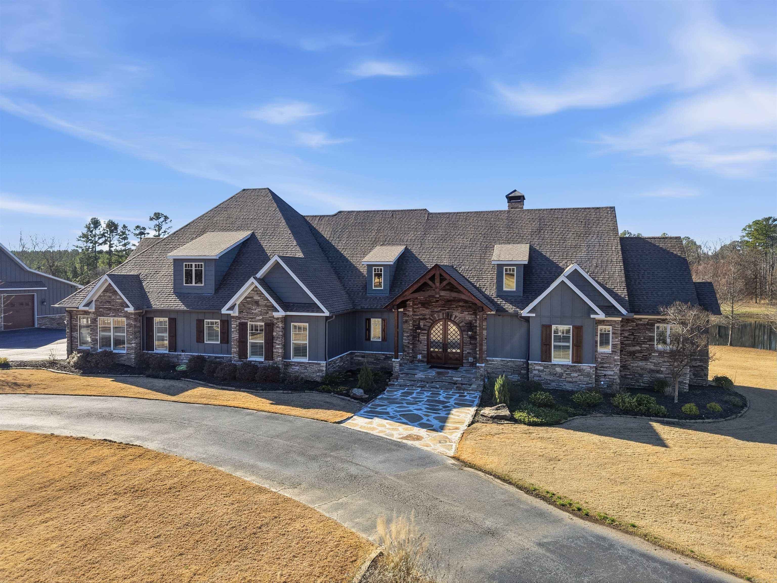 This remarkable estate is nestled on 10 pristine acres in the gated Westcliffe subdivision,offering privacy, luxury, and exceptional amenities.The home features a dramatic vaulted living room with mortise-and-tenon beams,a wood-burning fireplace, surround sound, and new televisions throughout.The kitchen is a showpiece with pecky cypress ceilings, custom cabinetry, high-end Thermador appliances, a copper farmhouse sink, reverse osmosis water filtration, and a butler’s pantry.Thoughtful additions include a safe room and a dedicated dog room with wash station.The luxurious primary suite features a jacuzzi tub, steam shower, his-and-her closets, plantation shutters, and marble vanities.The 3910 sf working barn/shop offers horse stalls, a tack room, workshop, half bath and hunting closet. Above,a 1000sf apartment w/a bunk room with two queen beds, full kitchen, living room, and full bath—perfect for guests.Step outside to enjoy the gunite pool, hot tub, and a fully stocked pond with irrigation system, a fully equipped outdoor kitchen,bar,and wood-burning fireplace for entertaining year-round.A rare opportunity to own an estate that truly has it all—luxury, land and lifestyle!
