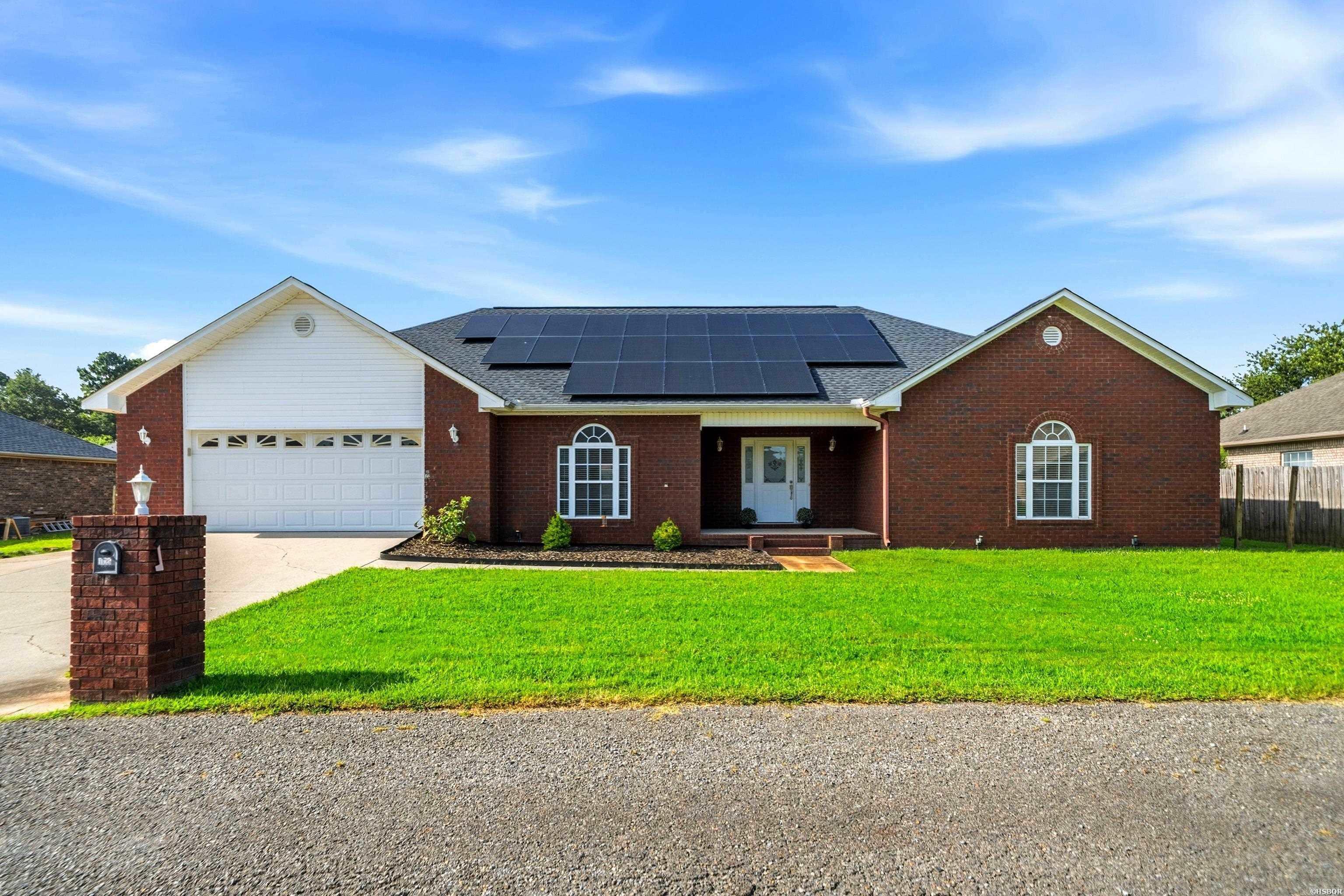 Welcome home to this beautiful, move-in-ready one-level residence perfectly situated in the highly sought-after Lake Hamilton School District, located just eleven minutes from the school campus. Built in 2006, this 2,720-square-foot home sits on a completely level lot, offering a highly functional layout inside and out with a flat backyard perfect for outdoor activities and easy maintenance. A standout feature of this property is the solar panel system, which will be paid by the seller at closing, conveying to the new owner to provide savings on future electric bills from day one. Inside, the home offers fantastic versatility, featuring an eat-in kitchen area alongside a formal dining room that can easily be utilized as a home office, playroom, or flexible living space. The private primary suite serves as a spacious retreat, complete with a large en-suite bathroom and an impressive walk-in closet. The remaining three bedrooms are well-proportioned for family or guests, with two featuring their own walk-in closets for excellent storage. A dedicated laundry room adds everyday convenience to this exceptionally well-maintained home.