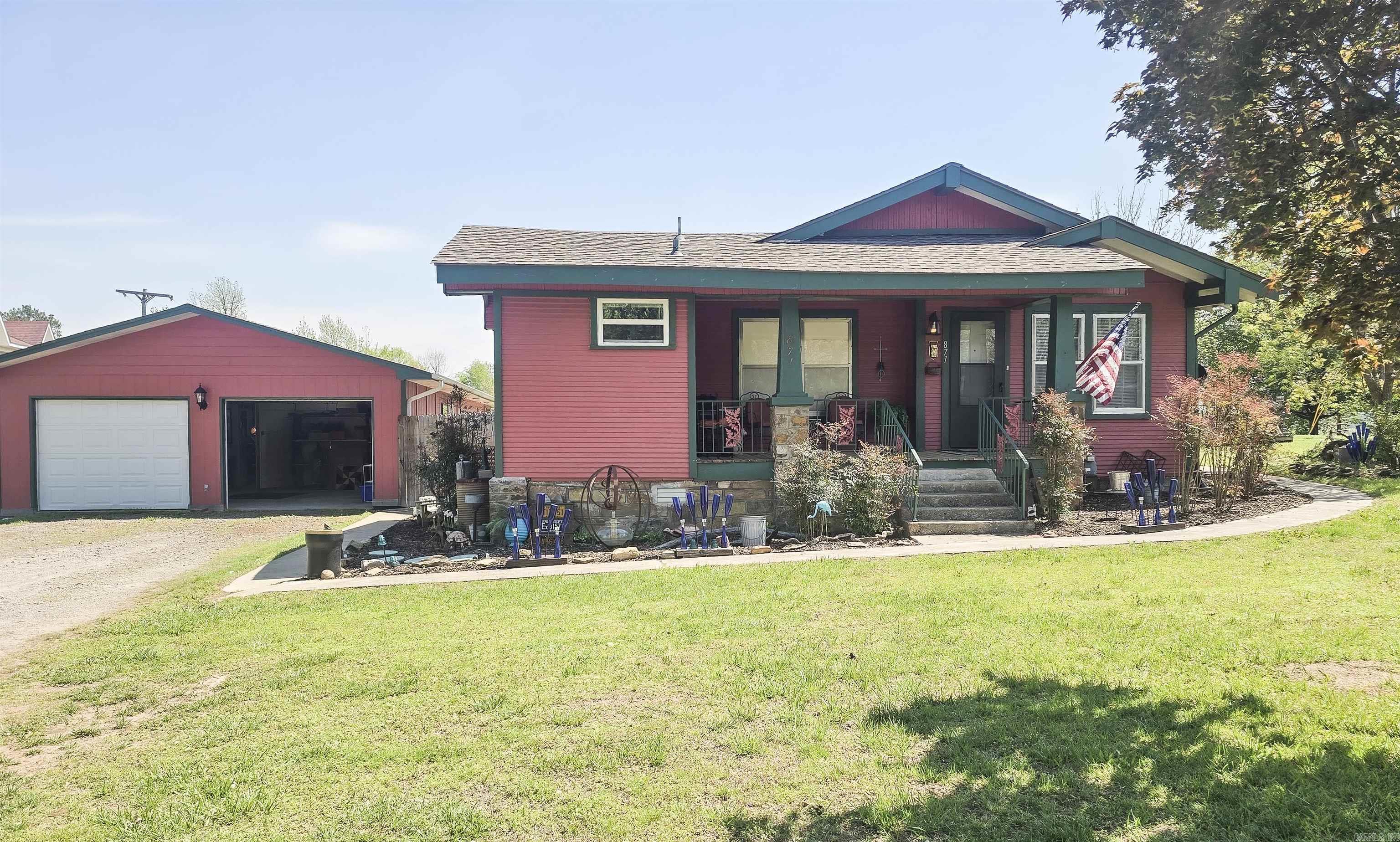 This well-cared-for 3-bed, 2-bath farmhouse in Clinton was built in 1932 and sits on 1.5 acres of flat, usable land. The backyard is approximately an acre, with a 94-yo barn that's being used as a storage shed for yard tools.  The home is very clean & move-in-ready! Most floors are hardwood. New roof in 2024, front porch was rebuilt in 2025. Appliances and central air are 5 years old. Property taxes are 612.00 per year.  Great 50 x 25 detached 2-car garage with a heated & cooled workshop that has 220 electrical service and a 6ft x 25ft storage room.  This would be nice for a family to raise small livestock & garden - the back yard is the size of a football field! It could be a small farm, as it once was.  With some creativity and imagination, there are many possibilities! Some ideas could include a contractor's office and yard, restaurant, storage units, auction yard, etc. The current owner restores and sells antiques and yard art from the property and has three or four large sales per year, with tons of parking in the back.