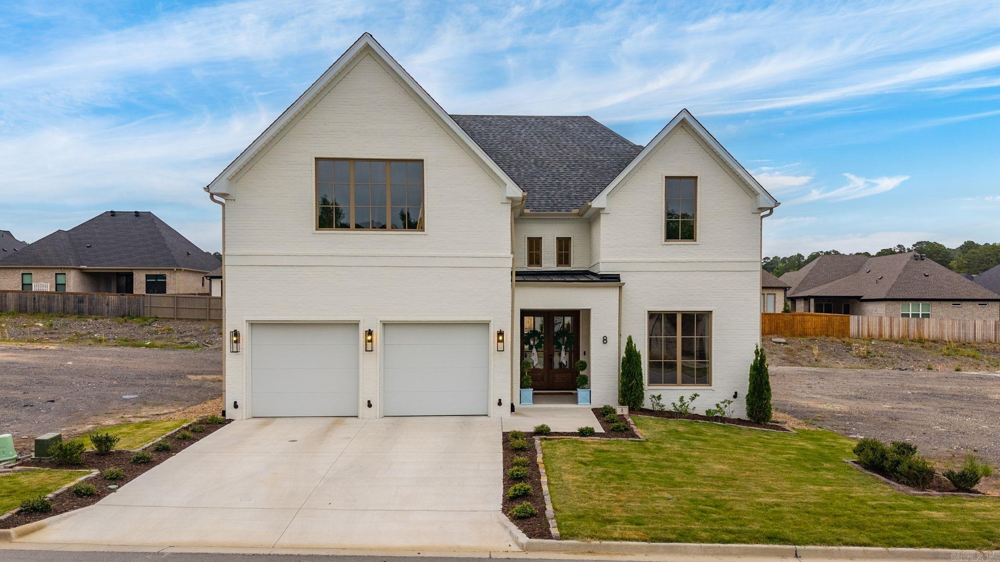 Agents see remarks regarding exclusions and possession date. Stunning custom home built by Bud Thomas and completed in 2025. Essentially new construction with beautiful details and upgrades at every turn. Enter to soaring ceiling and gorgeous rounded doorways. The kitchen and dining spaces are a dream for entertaining featuring elegant fixtures, quartz countertops, and Cafe appliances. The primary suite is on the main level with a spa-like primary bathroom featuring his and hers vanities, heated floors, and steam shower. The second bedroom is on the main floor with adjacent bathroom. The third bedroom is up as well as a spacious bonus living space. The home was built with the possibility of a fourth bedroom in mind that could be added upstairs (currently attic space). Fireplaces in the main living room, outside on the covered patio, and in the primary suite. Surround sound in living area and patio. Gracious yard.
