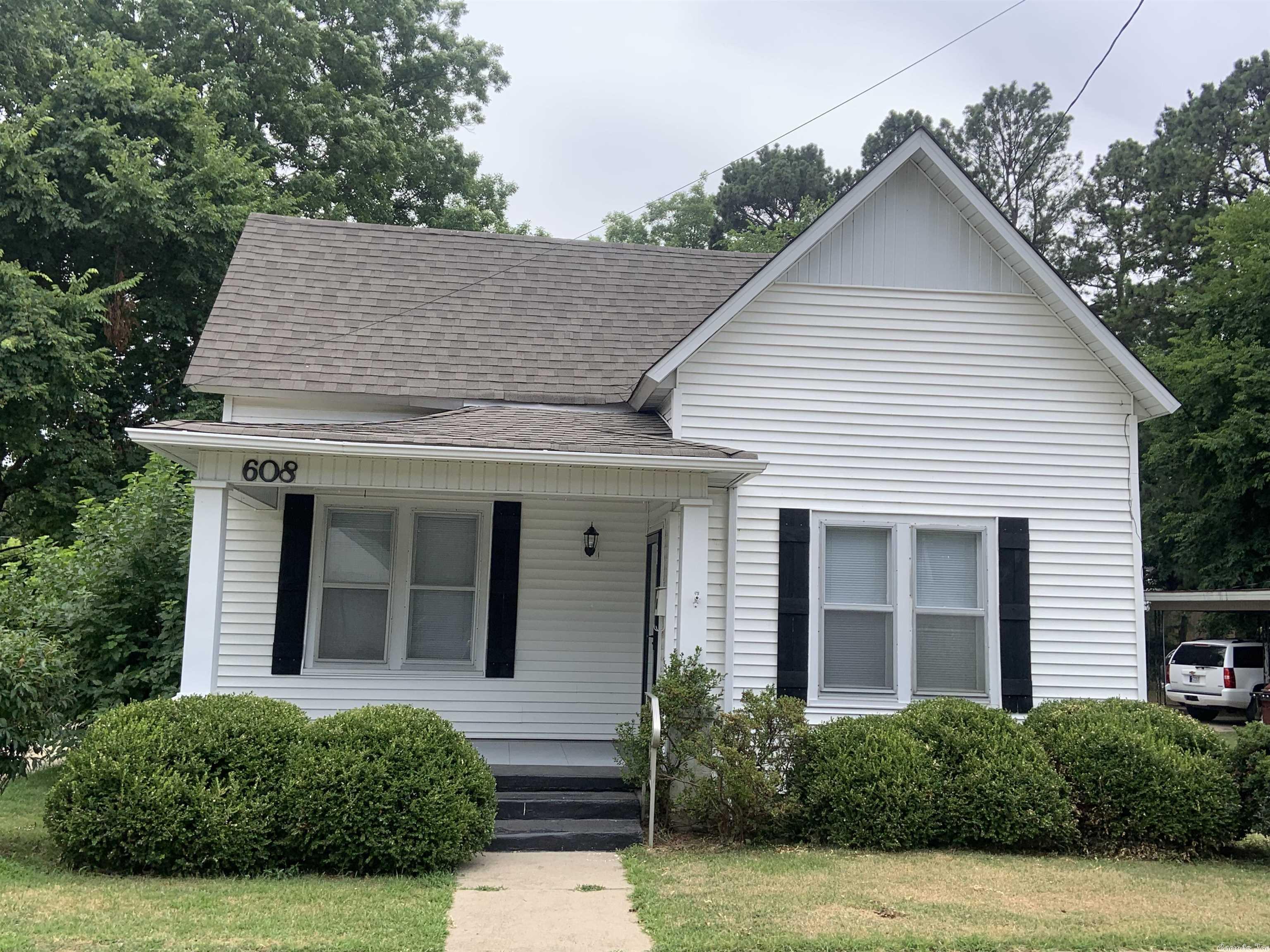Charming Older Home, Completely updated Interior. Paint, hardware, fixtures, appliances, Gas log Fireplace with built-in bookshelves in LR. Barn doors to close off kitchen  10 ft ceilings, wood floors,  beautiful  trims. Kitchen with all white cabinets, island bar, all  new appliances including refrigerator. Storm Windows,   Roof replaced 2021 Separate garage with storage room,  privacy fenced backyard,    Located close to downtown. See Agent Remarks