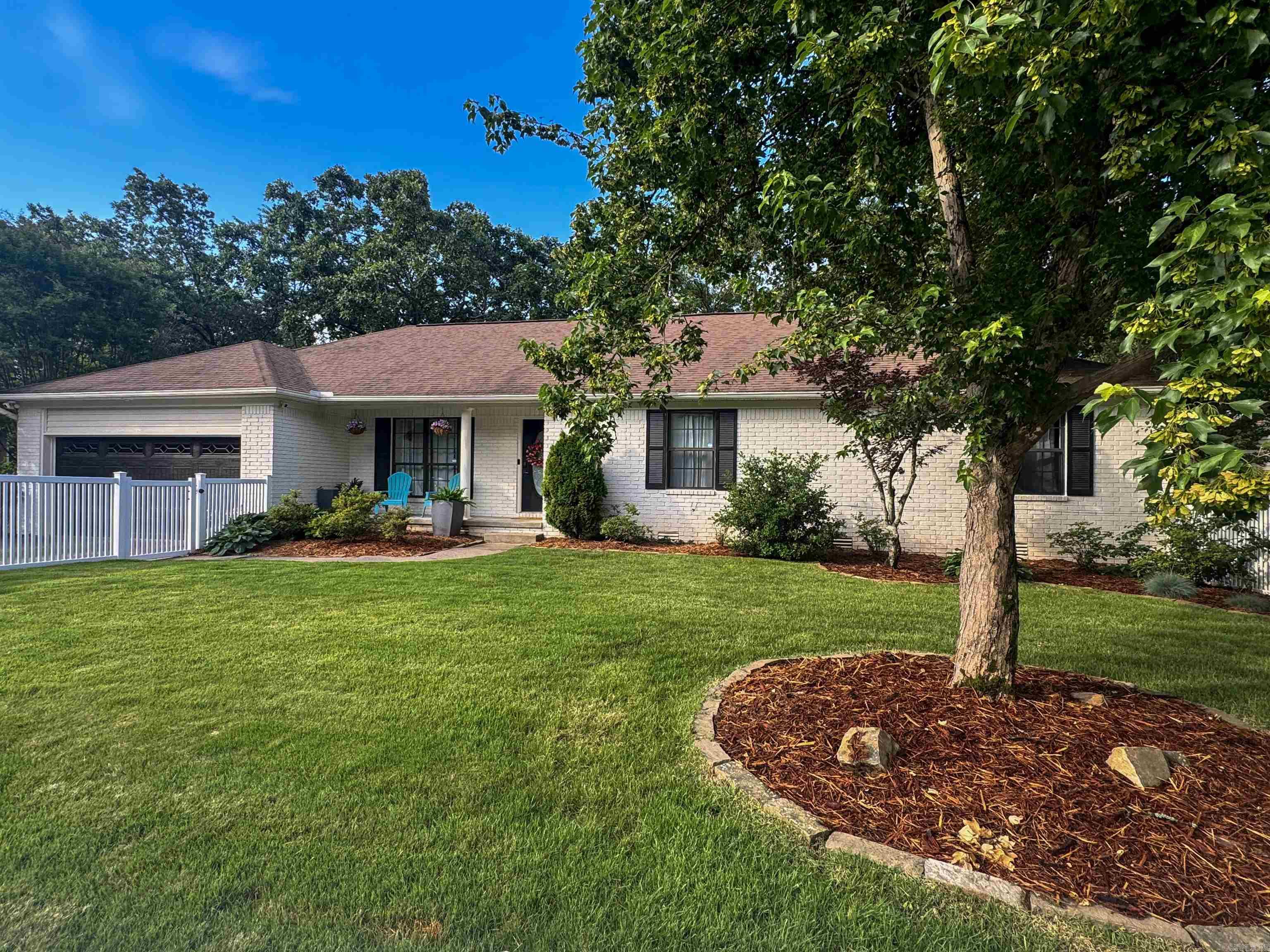 Newly landscaped, resodded, and exterior painted home on .48 acres in the heart of Little Rock. This location is loved for its ease of highway access but also the Don Roberts School Zone. A white vinyl front fence enhances privacy and creates additional flat usable yard space. Outdoor living is just as impressive as the interior, with a 10x20 screened-in porch looking at the private wooded backyard and a fenced area beneath the porch enhanced with turf installation (2020). Inside a cathedral ceiling in the 18’ x 20’ living room, natural light and custom built-ins frame the gas fireplace. Upstairs: Primary bedroom ensuite with 3 closets! 2 guest bedrooms + full bathroom, formal dining, living, and kitchen with eat-in. Incredible downstairs, where the fourth bedroom is equally as large as the upstairs primary suite, making it ideal for guests, older children, in-laws, or even a secondary primary suite option. The downstairs level also features a large rec room for movie nights or workout. The stair landing a flex space awaits. See update list. The privacy, multiple entertaining spaces + location makes this an exceptional opportunity for buyers seeking schools/work prox. and fun!