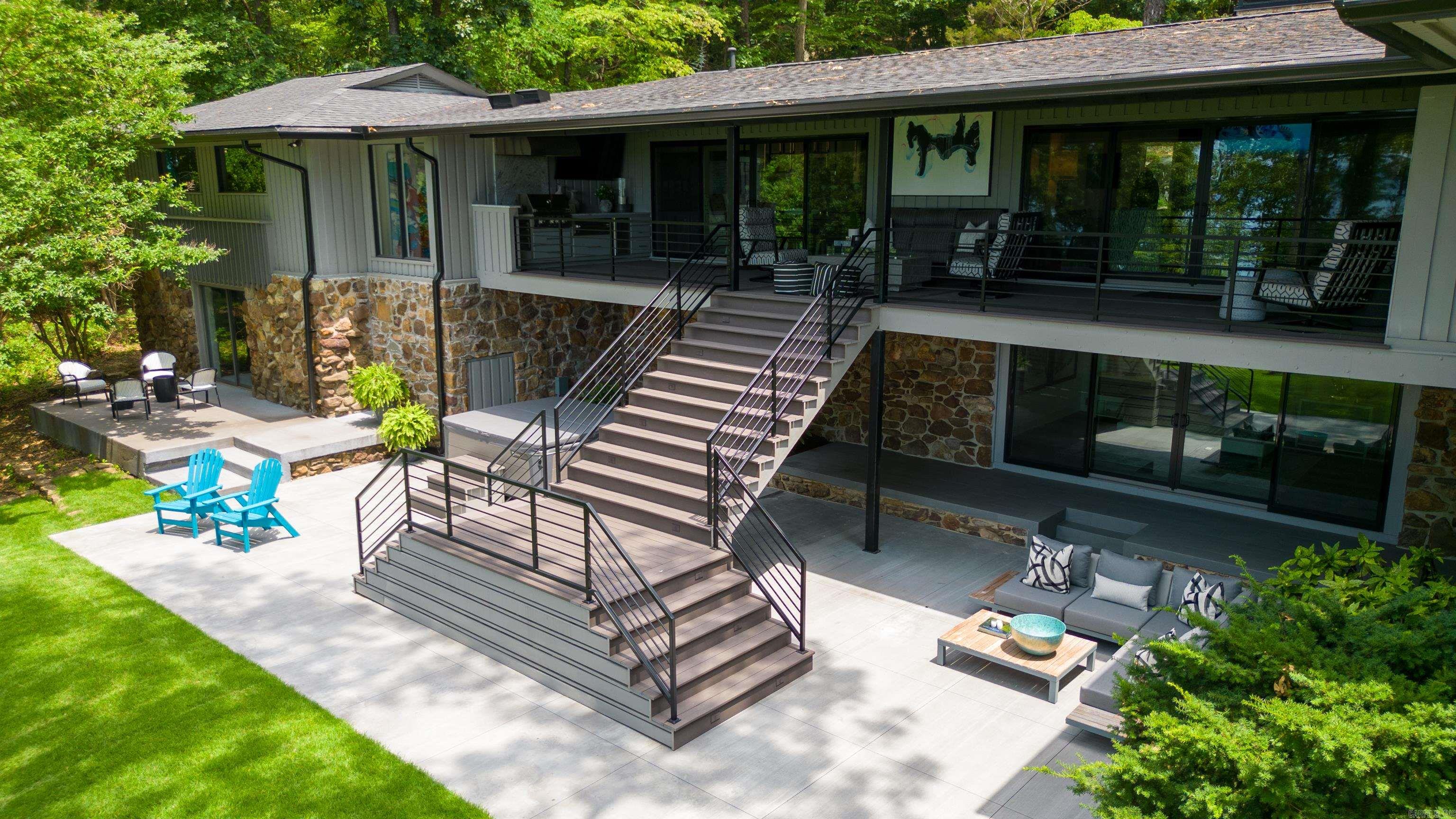 Eden Isle LAKEFRONT with probably one of the best views on the island. Welcome to your dream designer home in Eden Isle on Greers Ferry Lake!  This exquisite waterfront property is a masterpiece of modern architecture and luxury, nestled in a serene and picturesque location on the shores of Greers Ferry Lake. Every aspect of this home has been meticulously designed and crafted, creating a harmonious blend of sophisticated elegance and comfortable living. This furnished home features 4 bedrooms, 4 baths & 2 half baths, gourmet kitchen, 2 living areas, great deck with outdoor kitchen, wet bar, large stone fireplace, 2 car garage and a 5 minute cart ride to Eden Isle Marina & Red Apple Inn.   So much to see with home and you will not be disappointed!