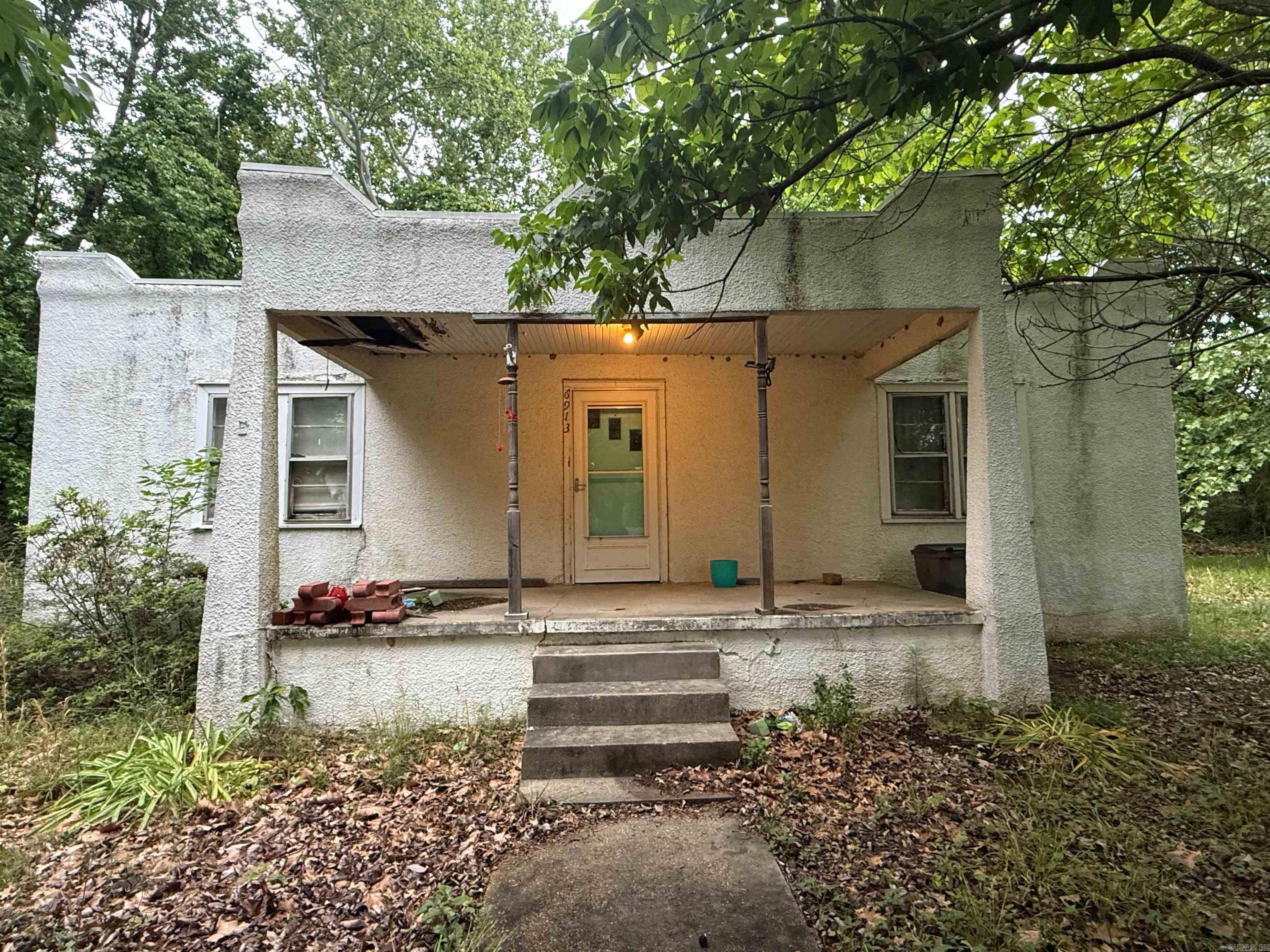 Looking for your next investment property or fixer-upper project? Look no further! This stucco home sitting on nearly a full acre could be just what you've been searching for.  Featuring approximately 1,400 sq ft on the main floor plus a basement, this property offers plenty of space and potential.  There a 3 bedrooms upstairs and an additional bedroom in the basement. Please note: property will not qualify for FHA, VA, or RD financing. Cash or in-house financing only.
